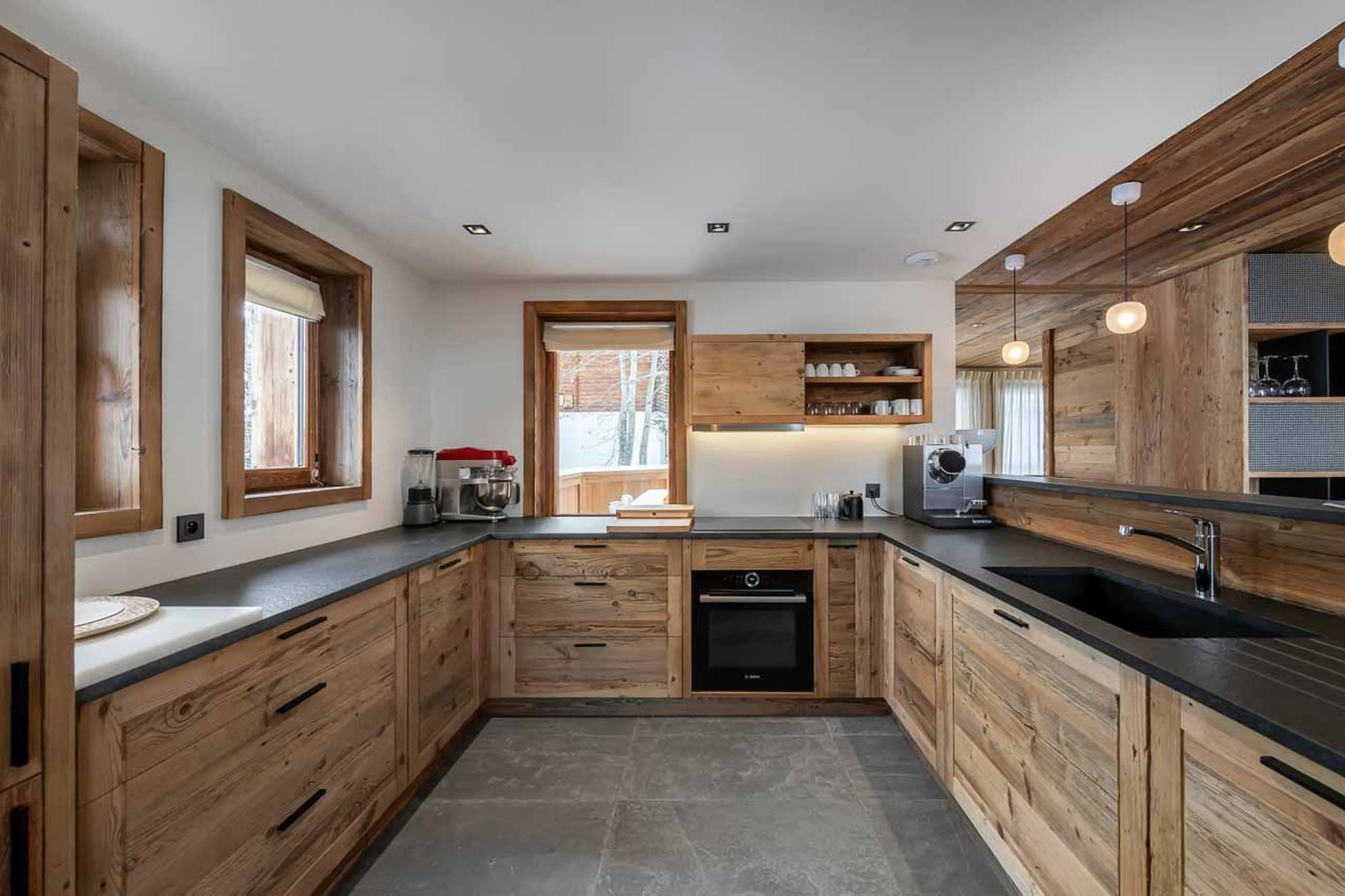 Semi-open fitted kitchen at Chalet CIUK in Courchevel 1550