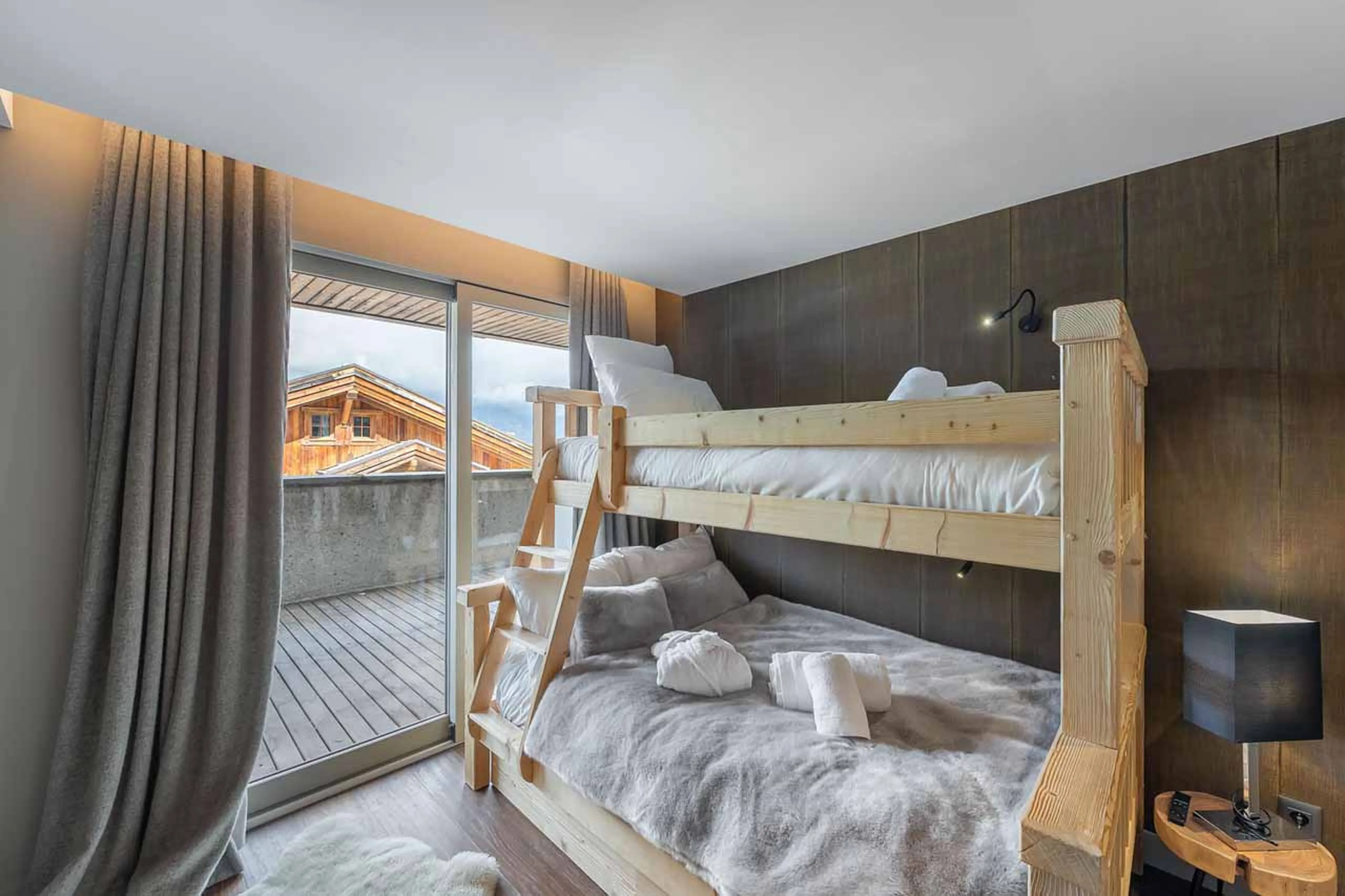 Double bunk bedroom with terrace access and en-suite shower room at Chalet Acelia in Courchevel 1550