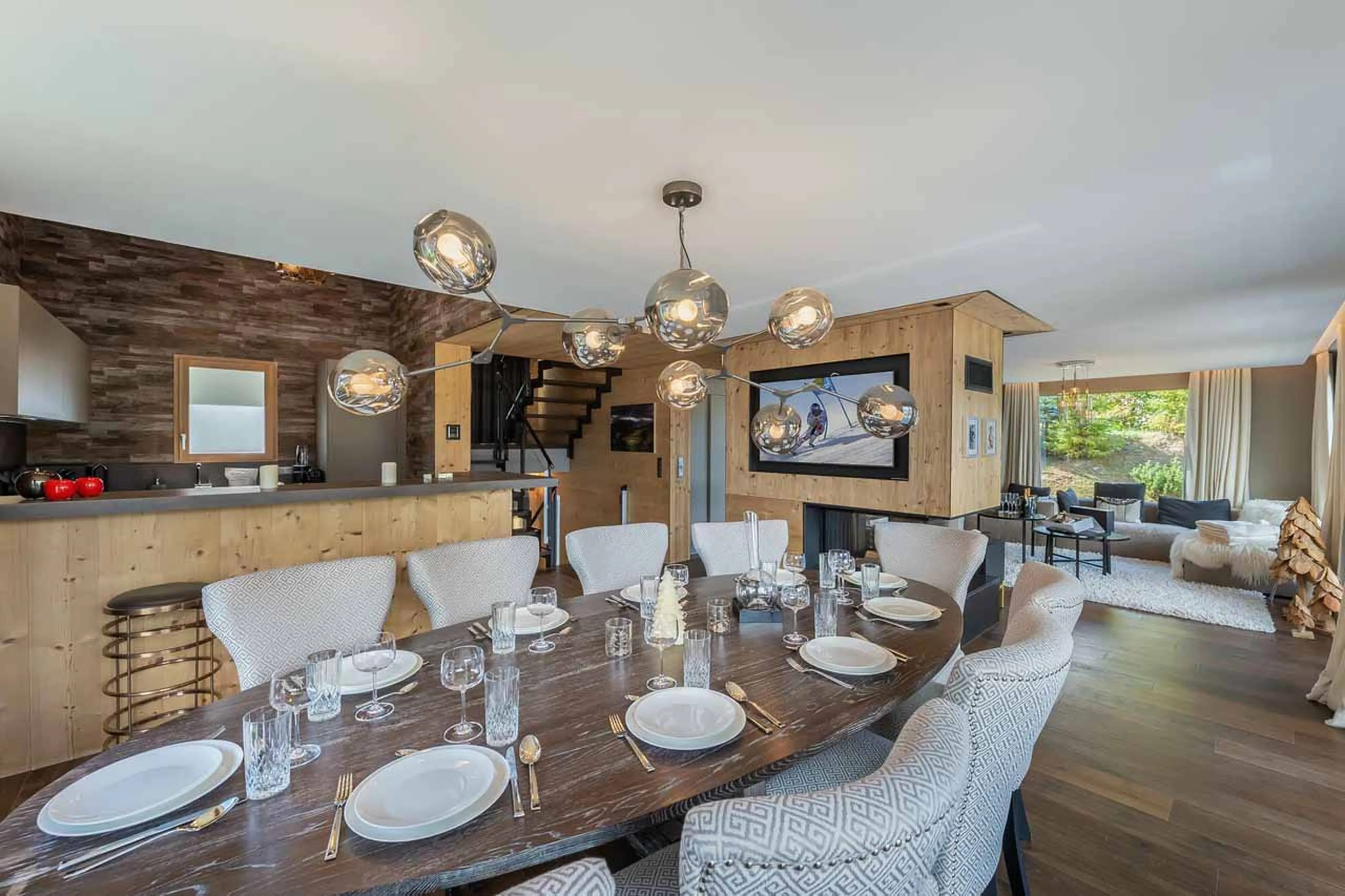 Bright and spacious living area with dining table at Chalet Acelia in Courchevel 1550