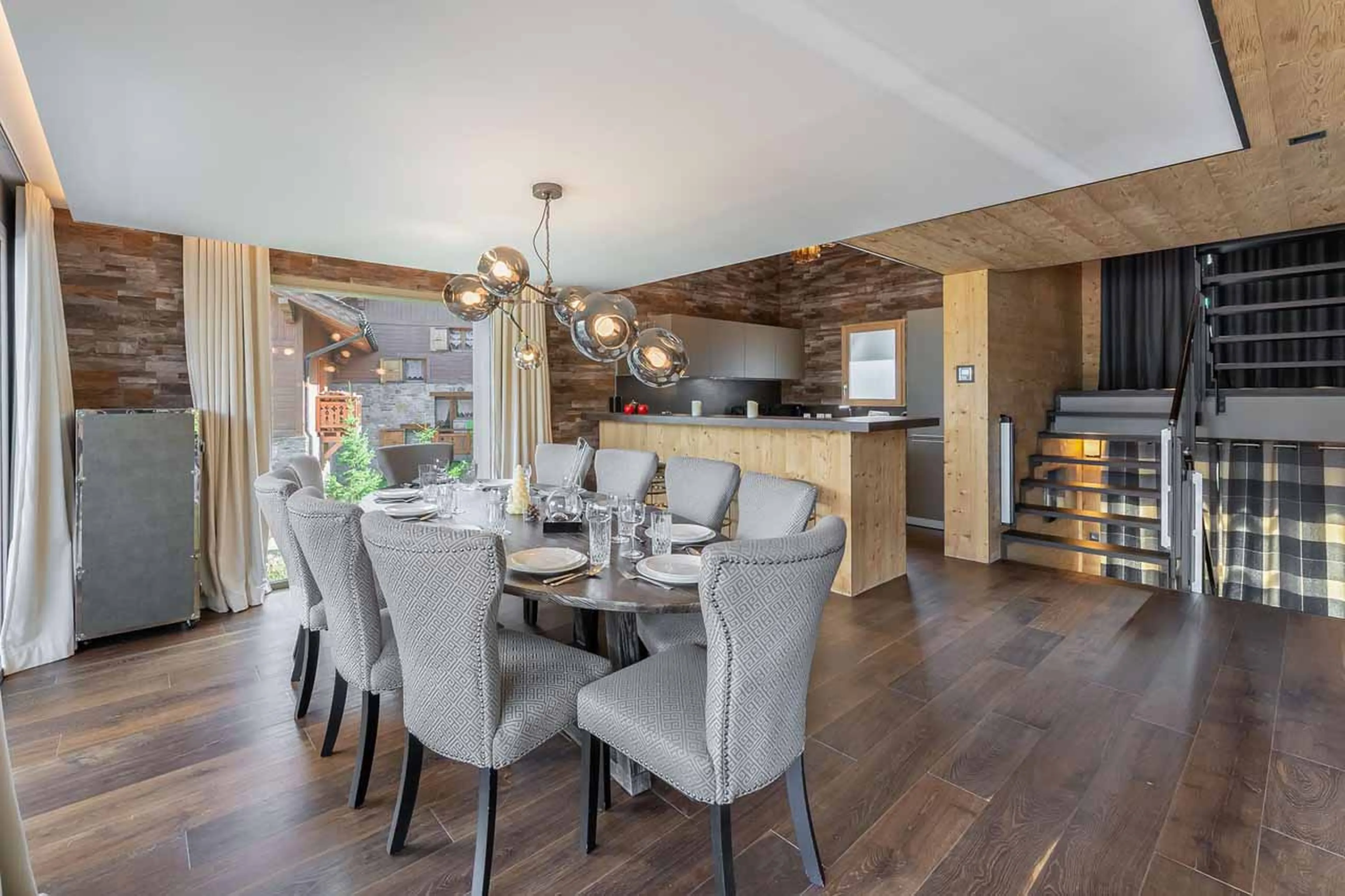 Dining space with access to open kitchen space at Chalet Acelia in Courchevel 1550