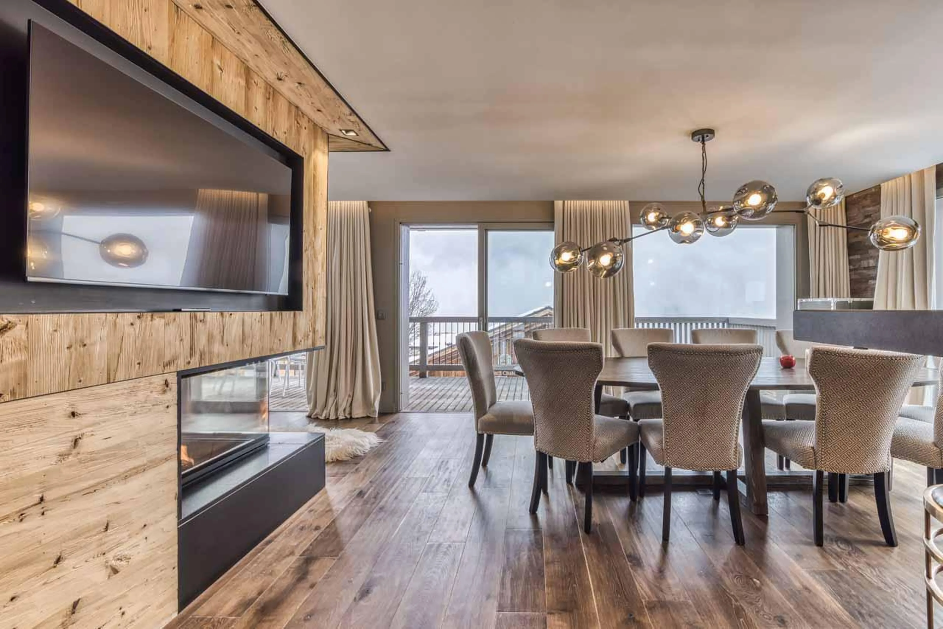 Bright and spacious living area with dining table at Chalet Acelia in Courchevel 1550