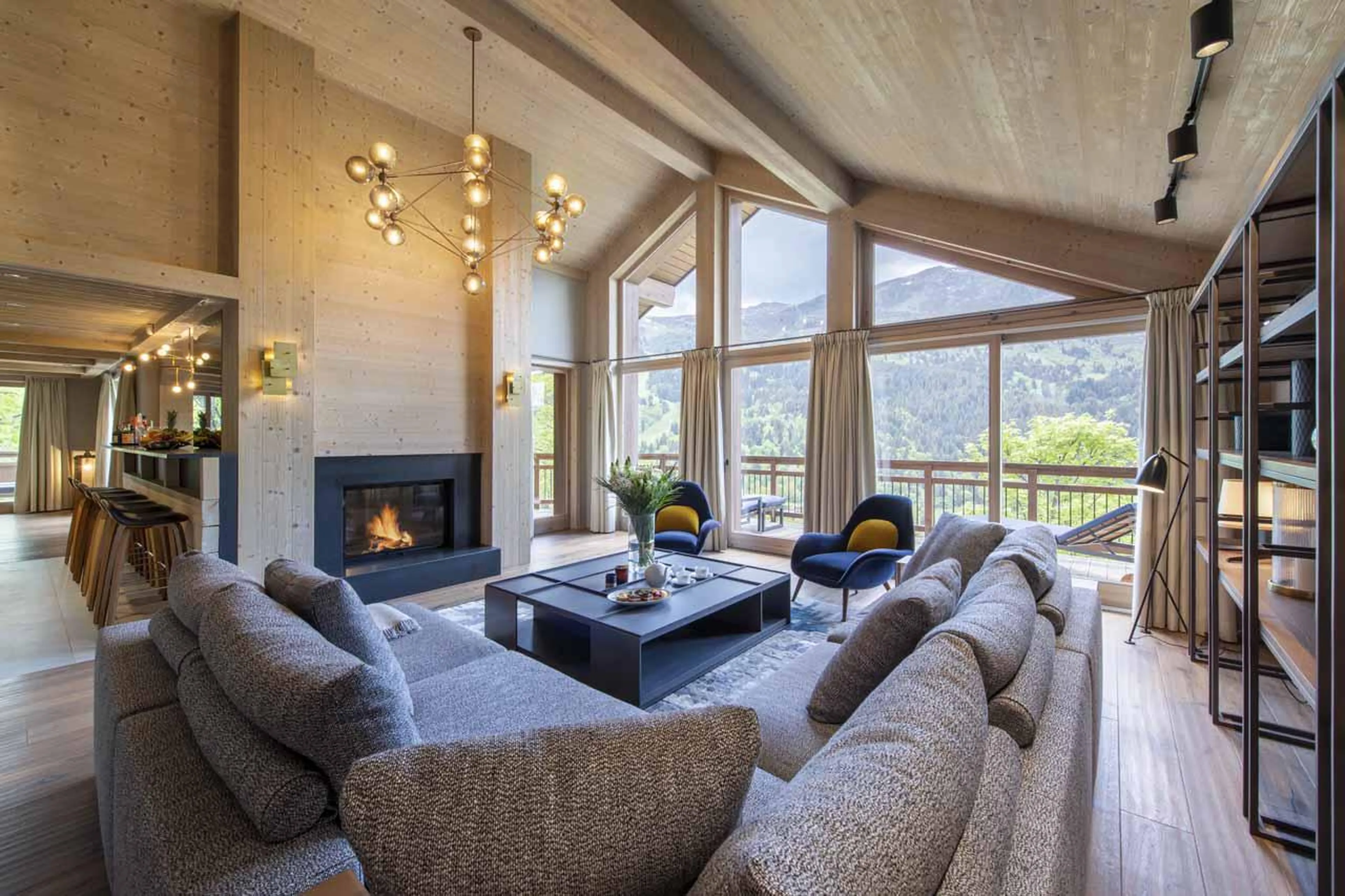 Living room with vaulted ceiling and fireplace at Chalet Altius in Meribel