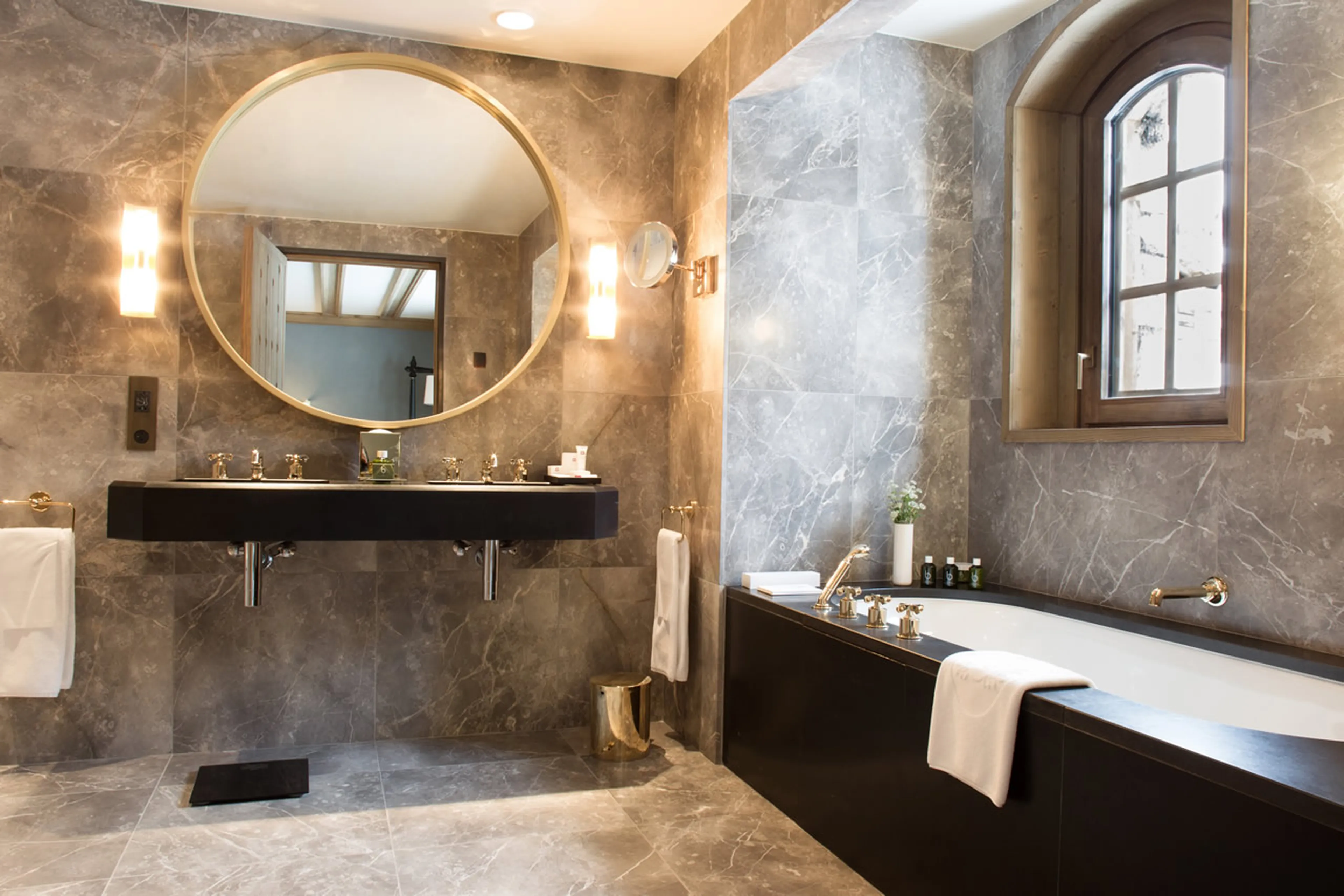 En suite marble bathroom with bath, shower and double basin in Chalet Amarante in Courchevel 1850