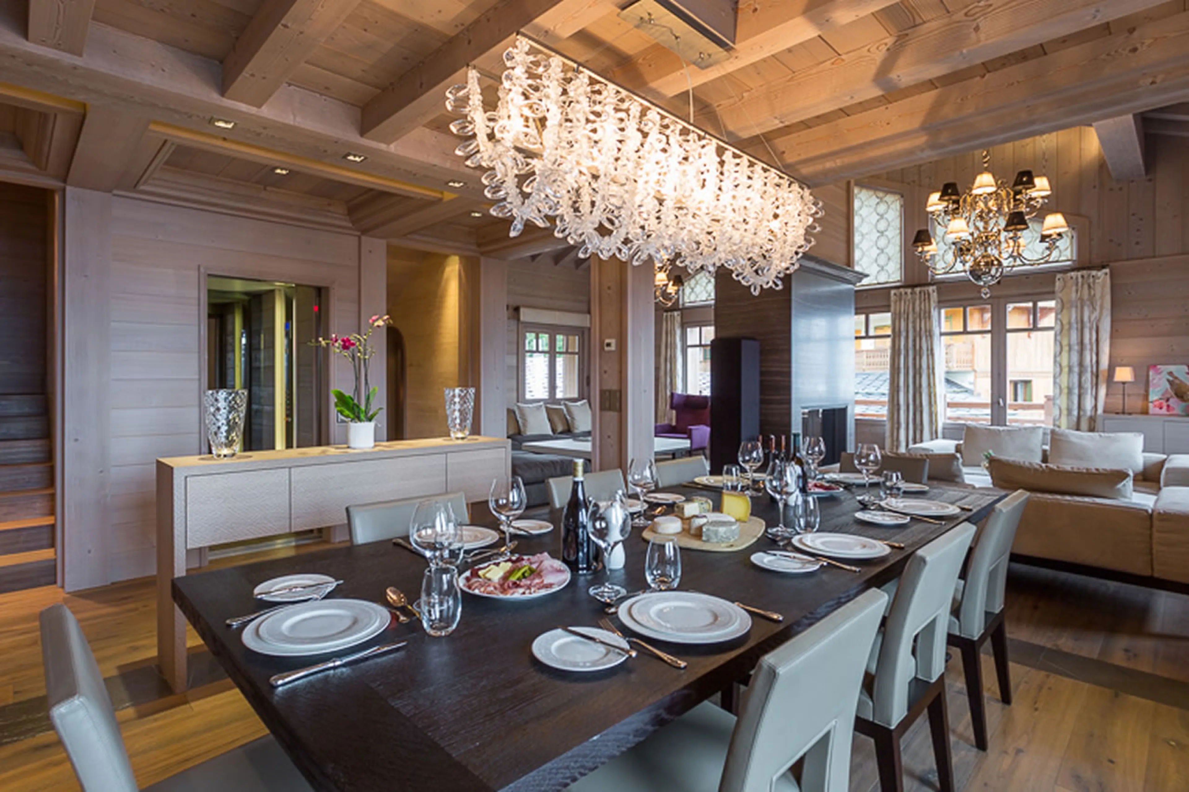 Dining section with beautiful chandelier in Chalet Anemone in Courchevel 1850