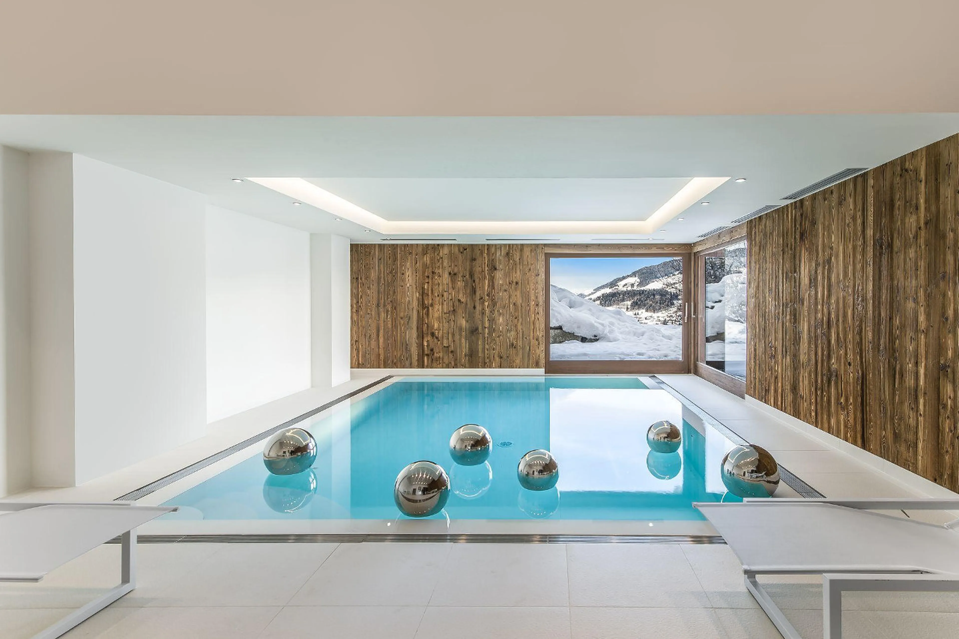 Modern indoor pale blue pool in Chalet Ararat in Megeve