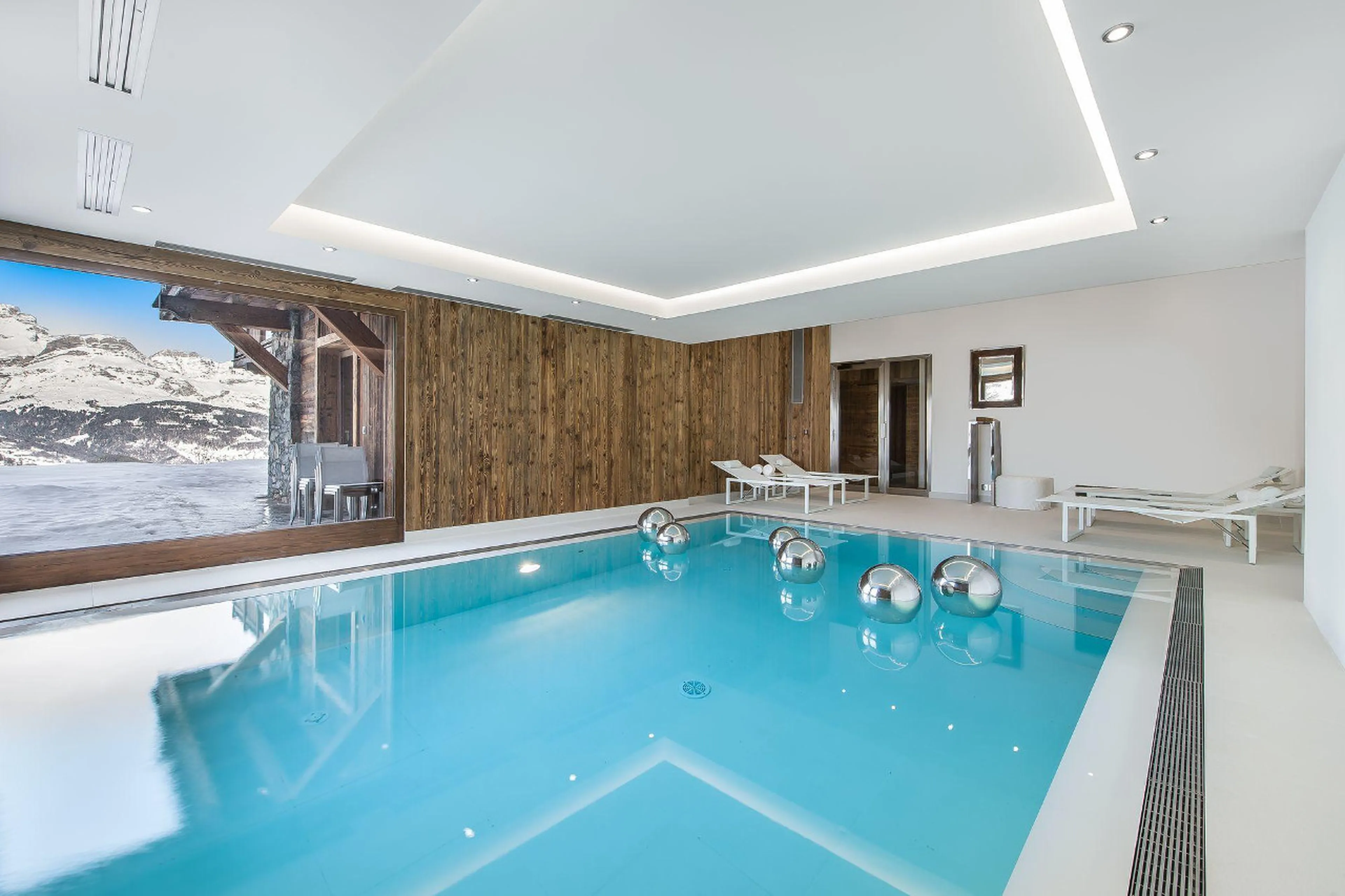The immaculate indoor pool area of chalet Ararat in Megeve has large windows