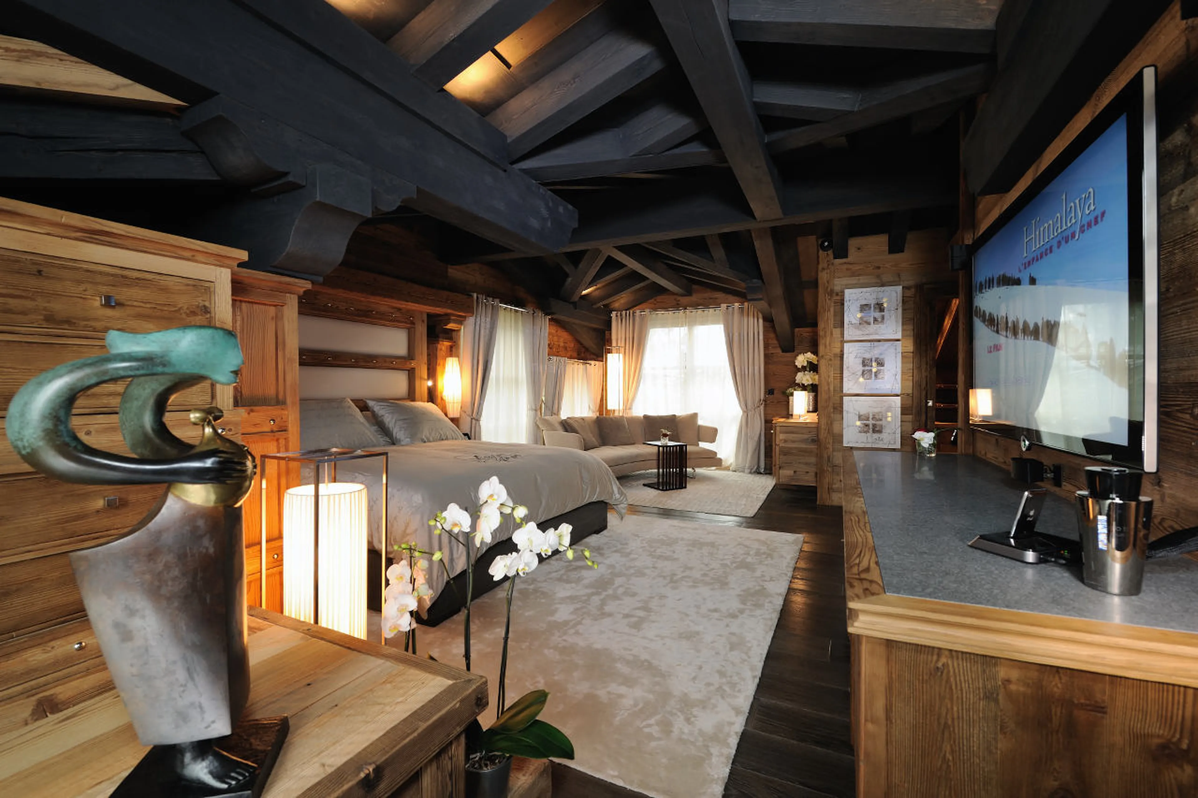 Fireplace and balcony access are two plus points of this bedroom in Chalet Art in Courchevel 1850