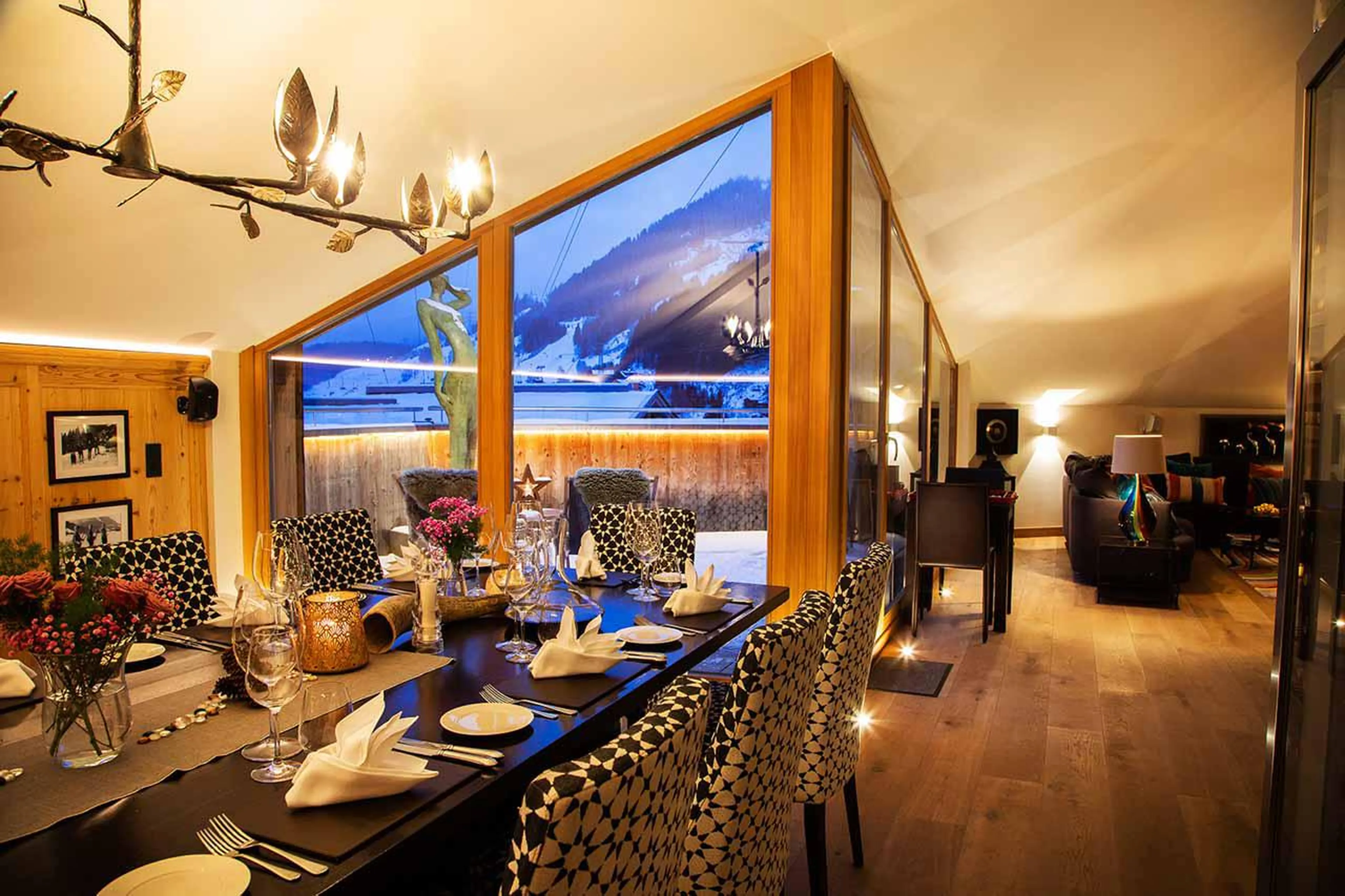 Elegant dining area at night at Chalet Artemis in St Anton