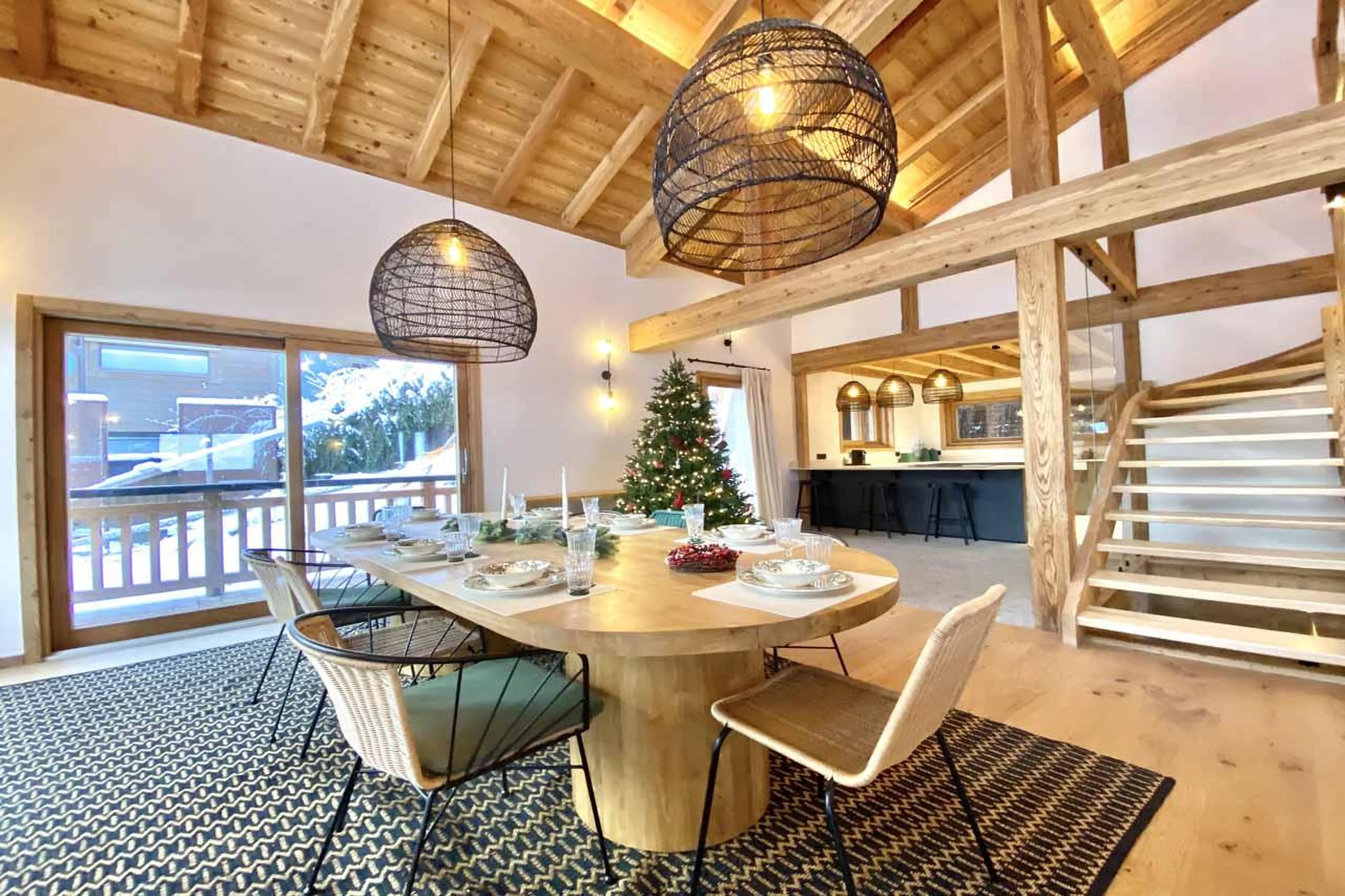 Dining table and chairs in front of sliding glass doors in Chalet Asgard, Morzine