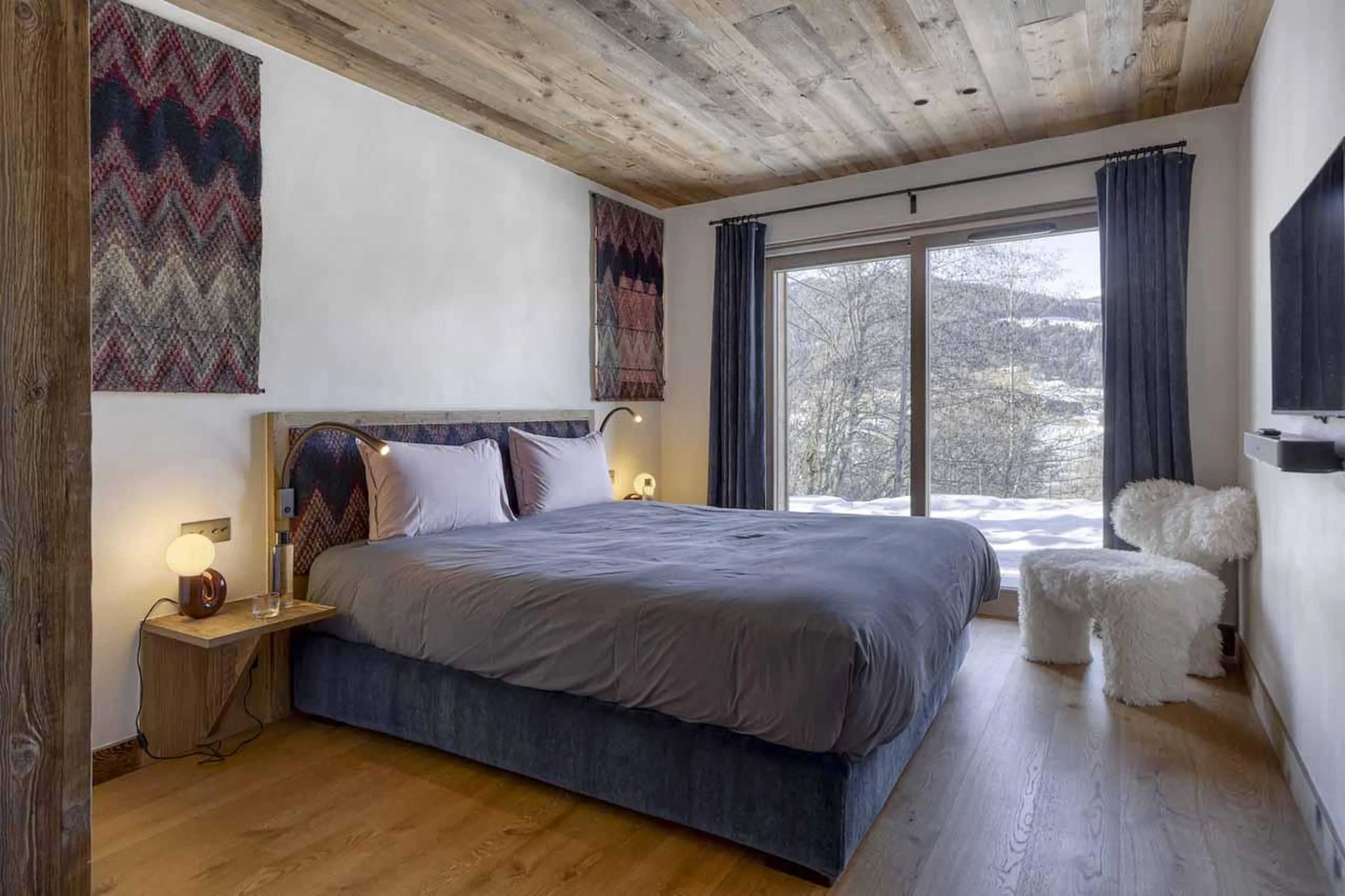 Double bedroom with sliding glass doors in Chalet Aspen, Megeve
