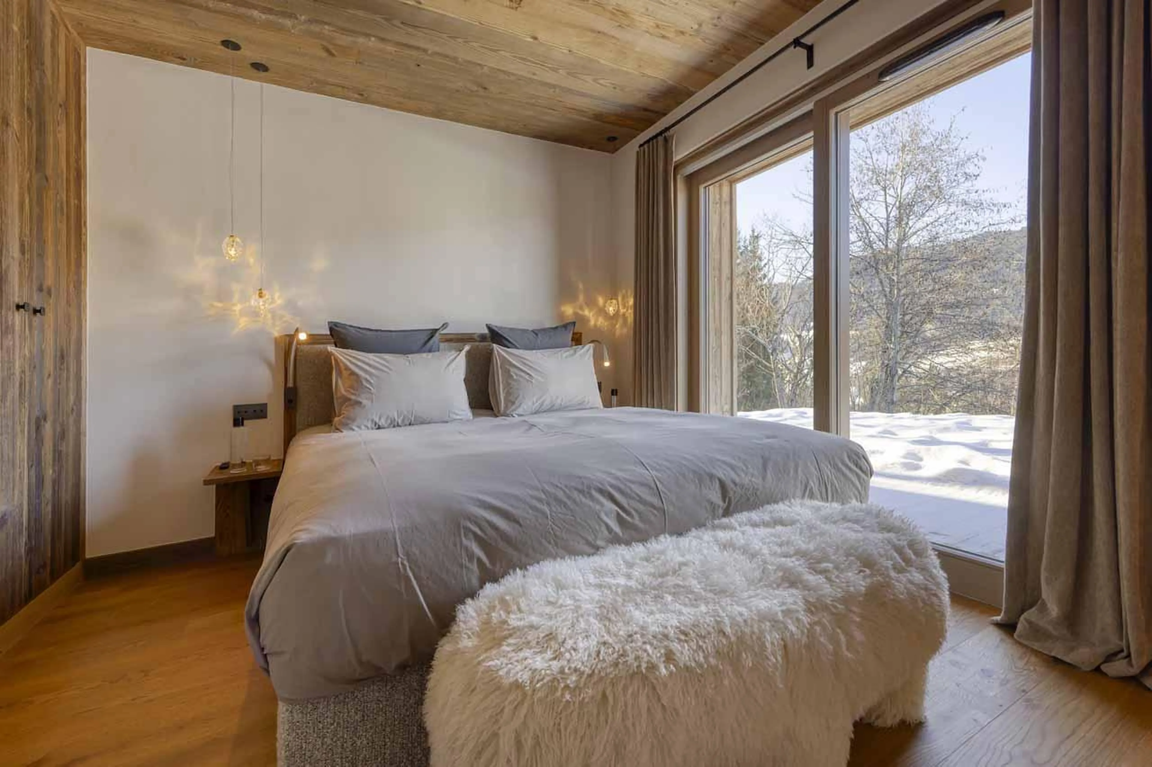 Double bedroom with sliding glass doors in Chalet Aspen, Megeve