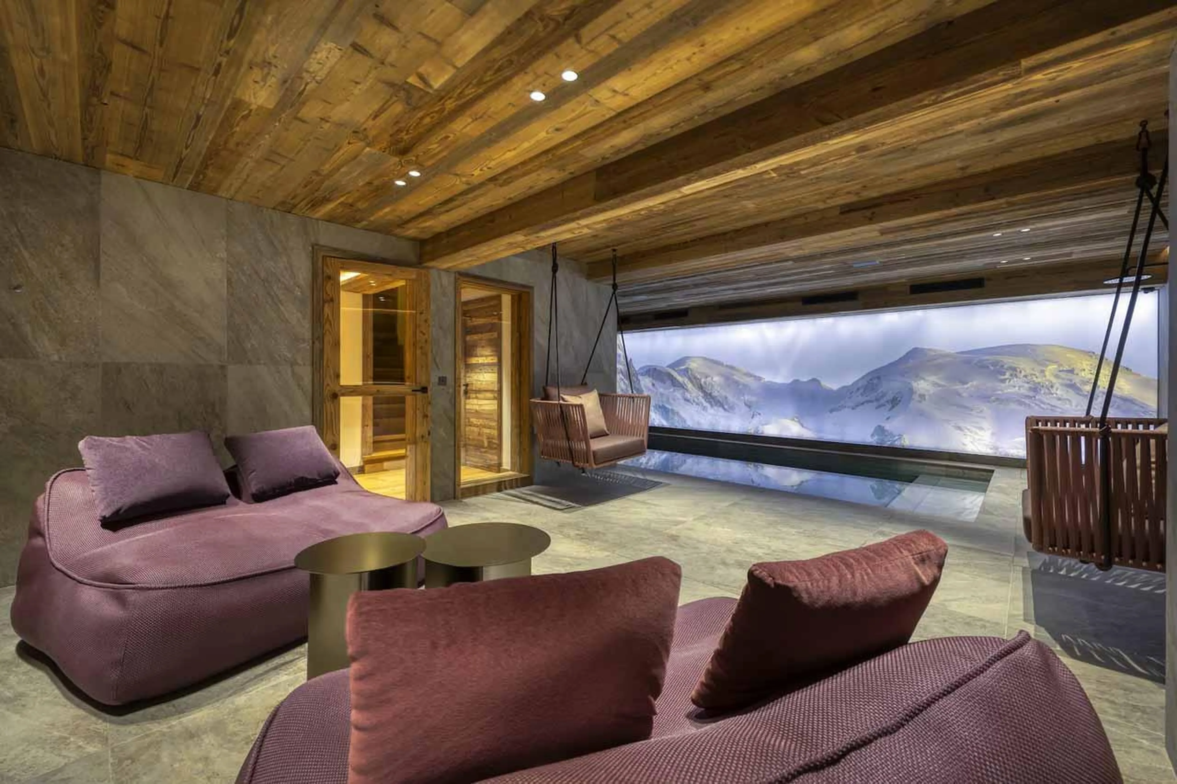 Relaxation area with sofas and swimming pool in Chalet Aspen, Megeve