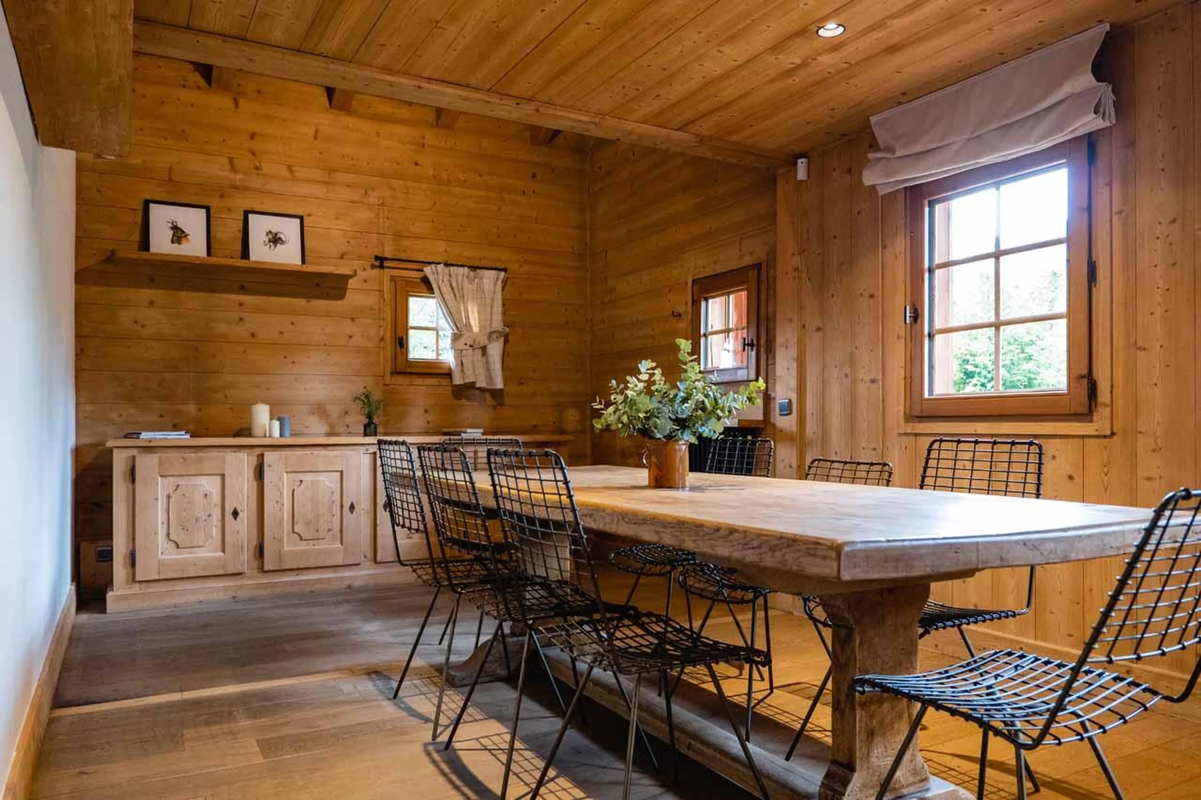 Dining area with long wooden table in Chalet Baltus, Megeve