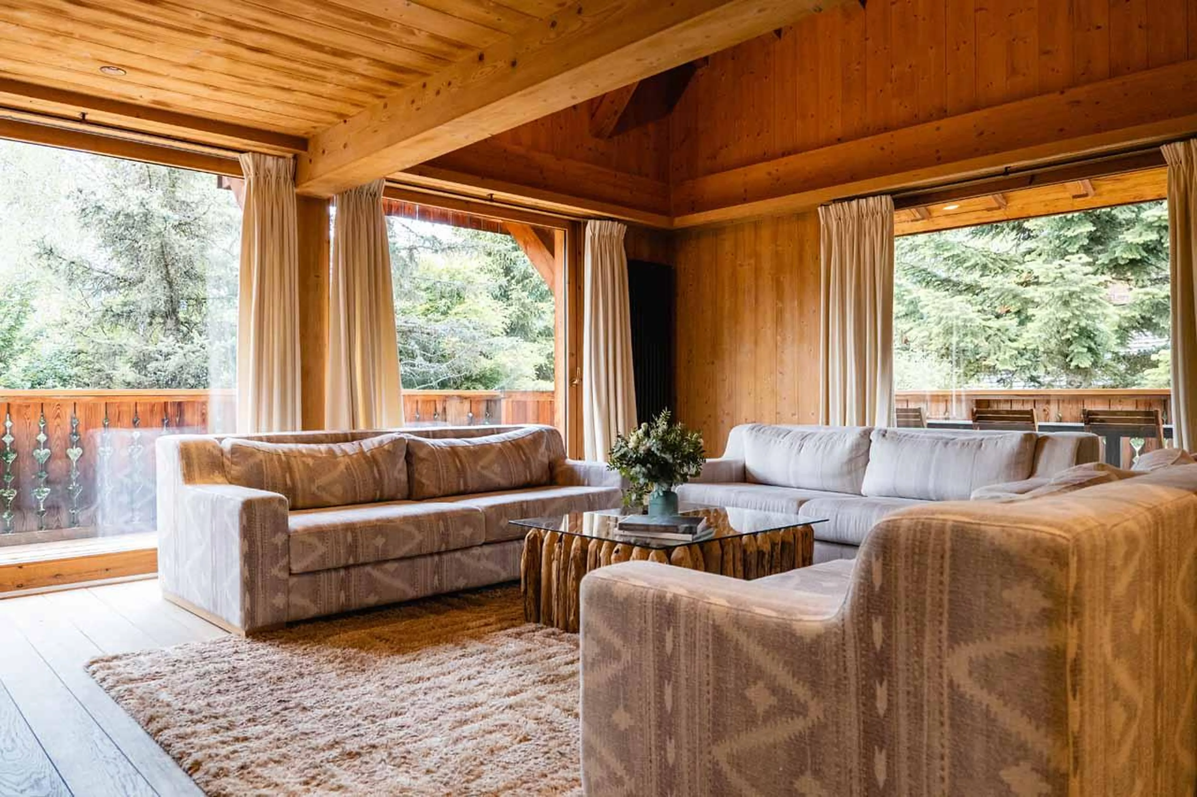 Sofas and floor-to-ceiling glass doors in Chalet Baltus, Megeve