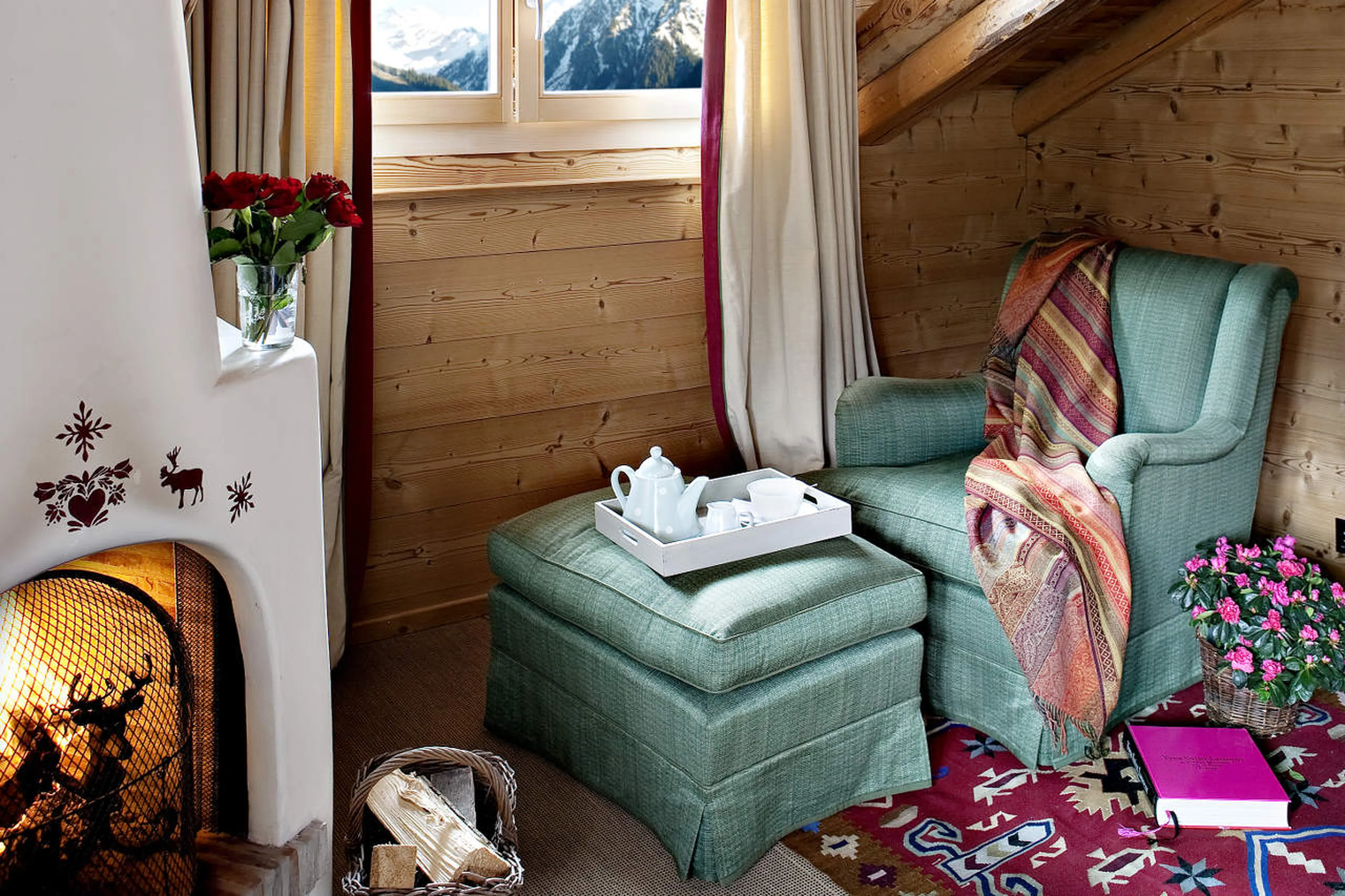 Snug fireplace corner in the master bedroom in Chalet Bear in Klosters