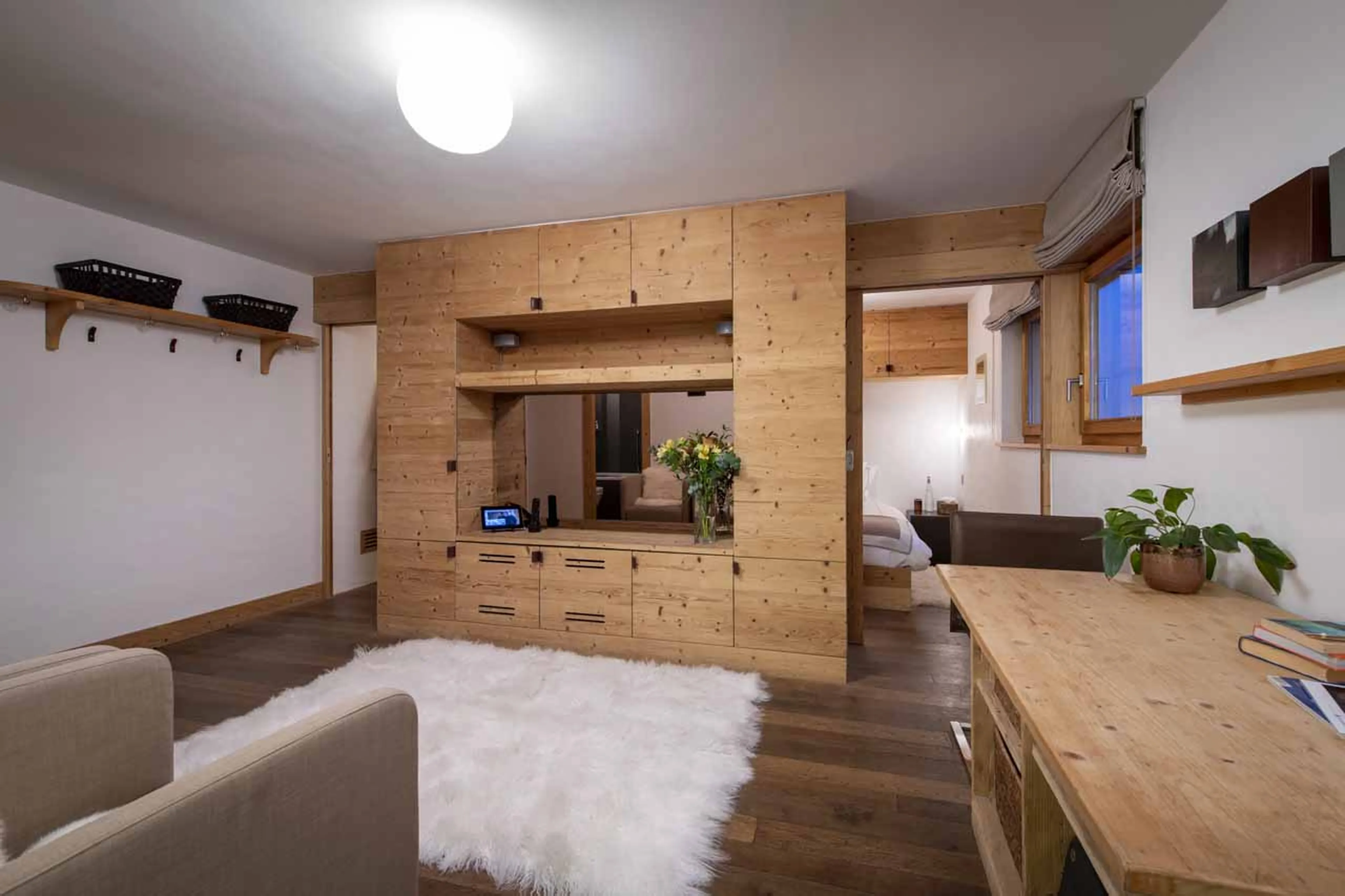 Living area and bedroom in studio of Chalet Belle Claire in Verbier