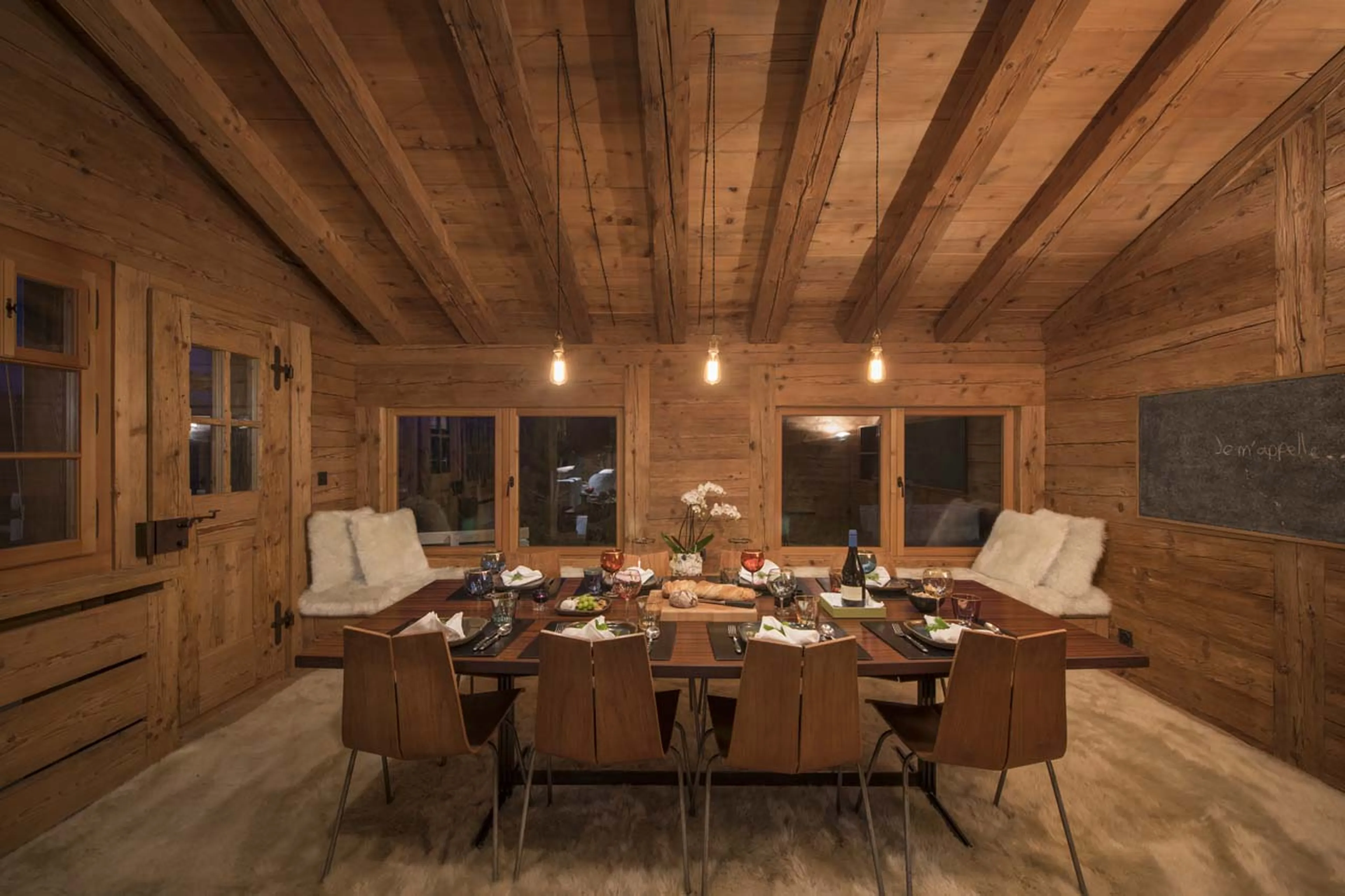 Dining room at night at Chalet Bibi in Verbier
