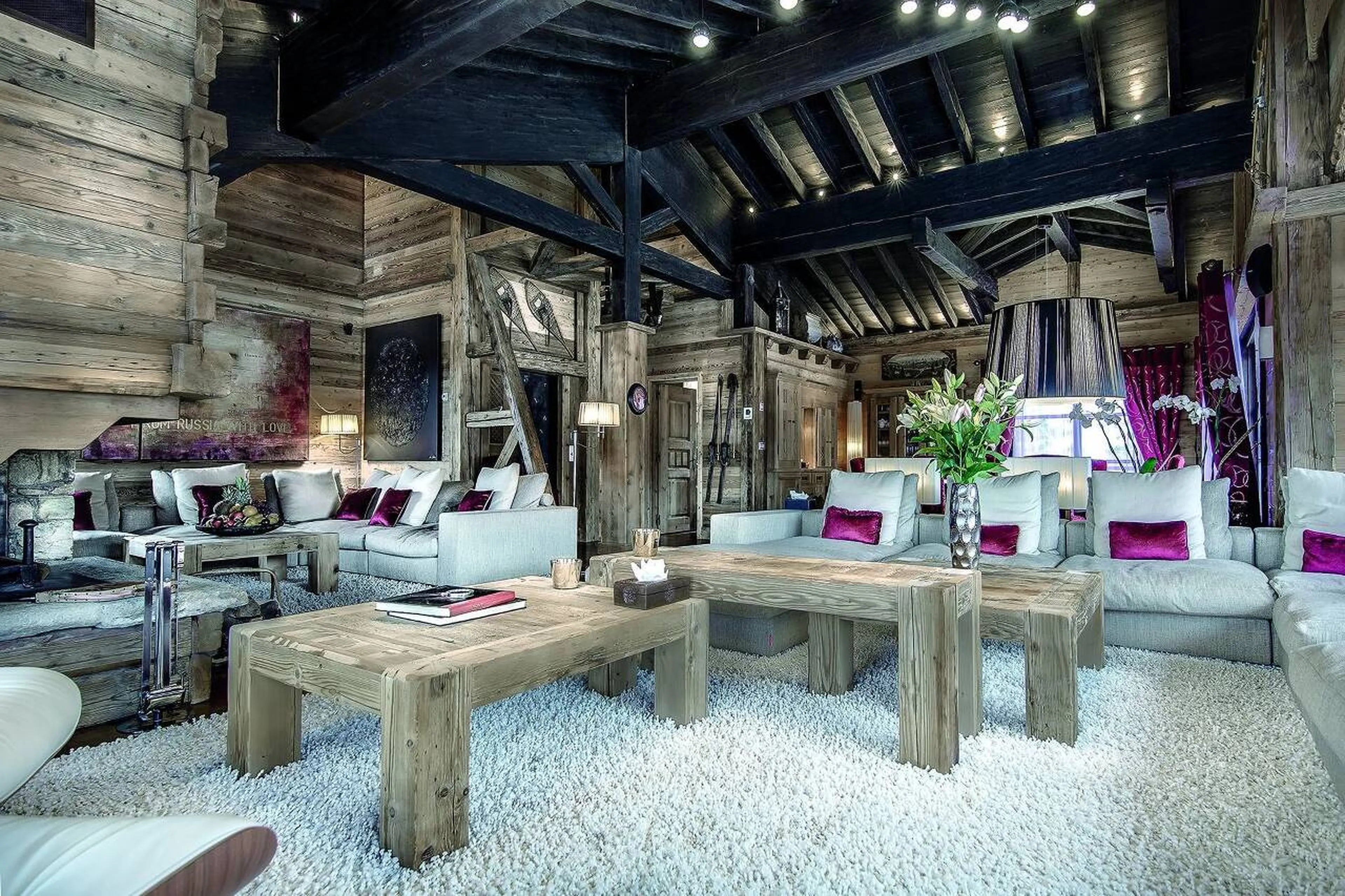Spacious lounge under black rafter beams in Chalet Black Pearl in Courchevel 1850