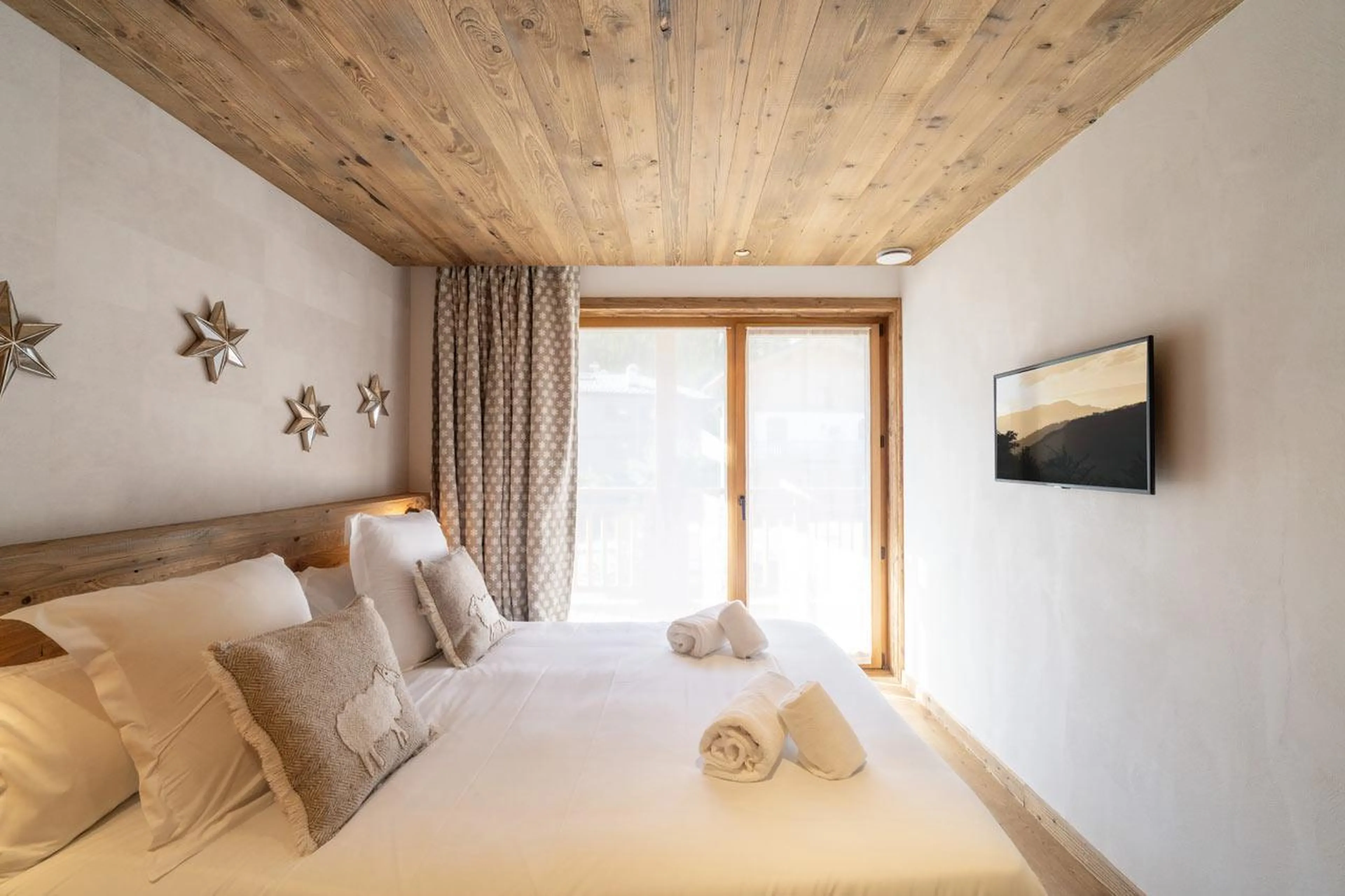 TV in bedroom at Chalet Bois de l'Abbaye in Courchevel Le Praz