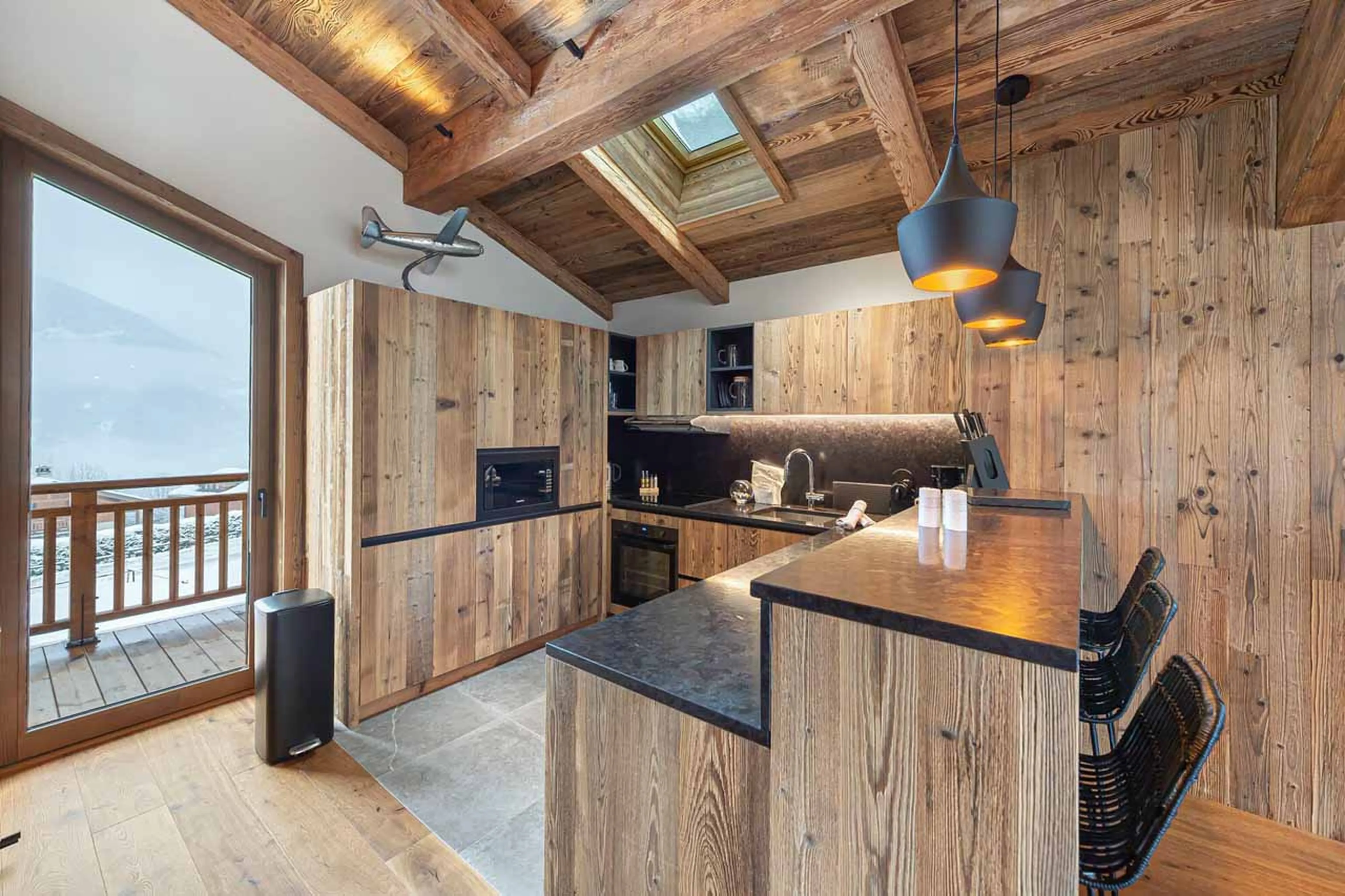 Kitchen & balcony at Chalet Bois du Ban in Courchevel Le Praz
