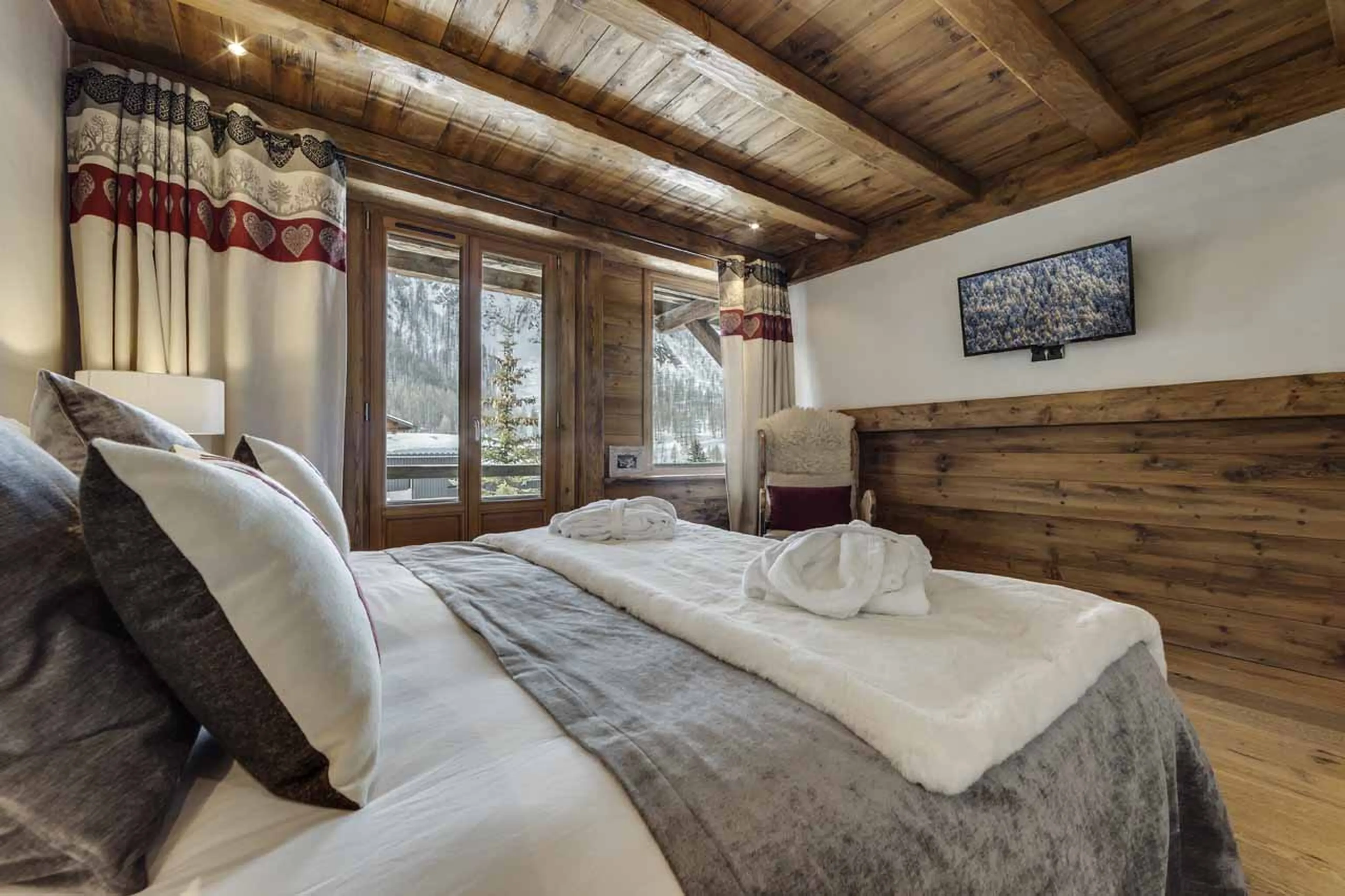 TV and balcony access from bedroom 2 at Chalet La Bouclia in Val d'Isere