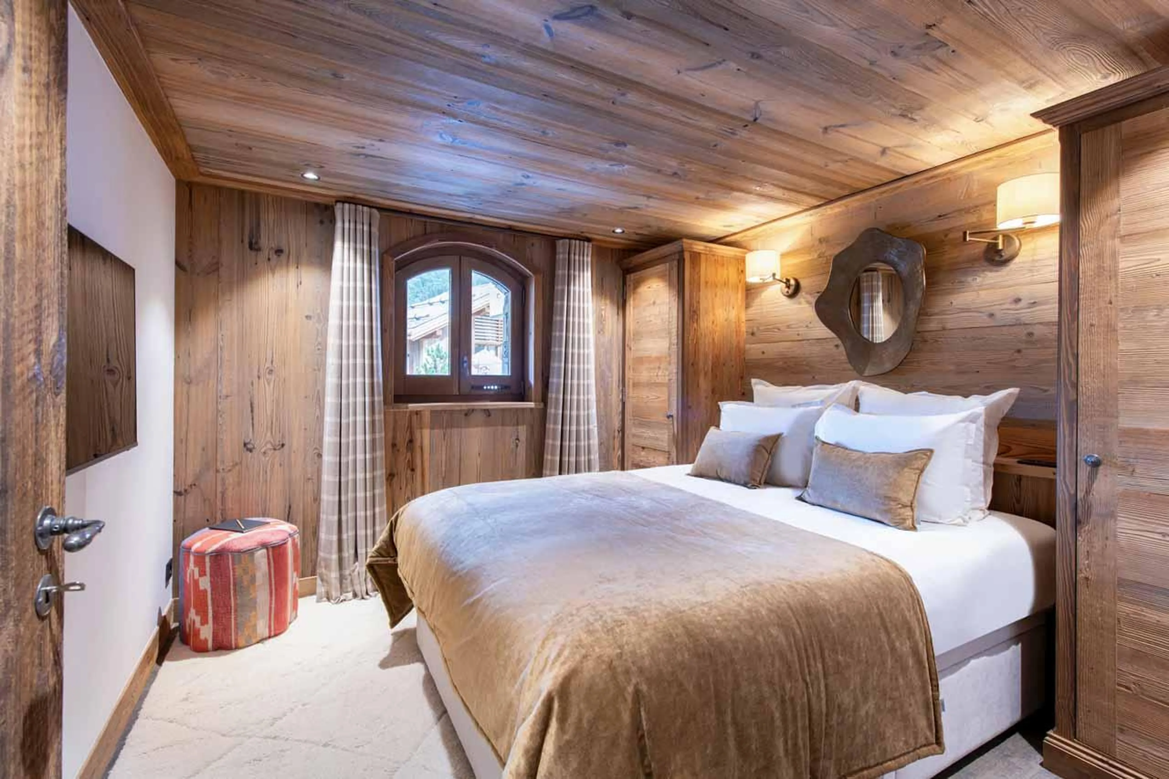 Double bedroom with TV and en-suite shower room in Chalet Caribou, Meribel