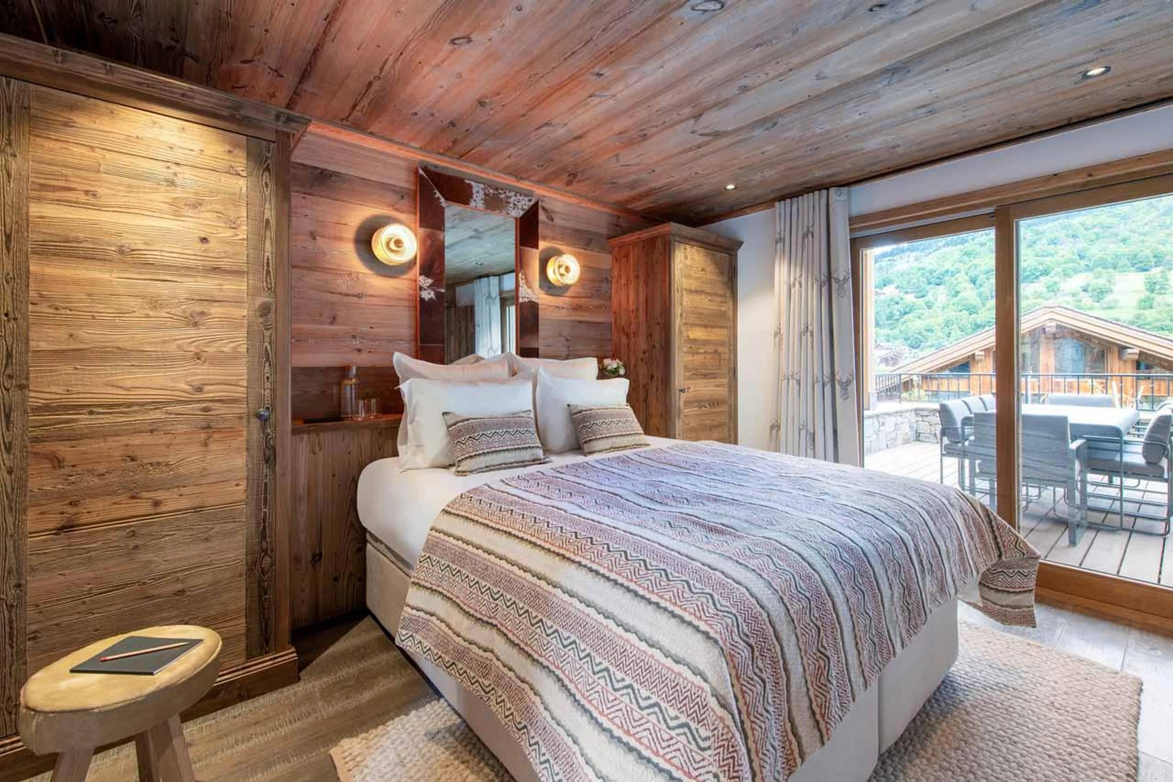 Double bedroom with terrace access and en-suite shower room in Chalet Caribou, Meribel