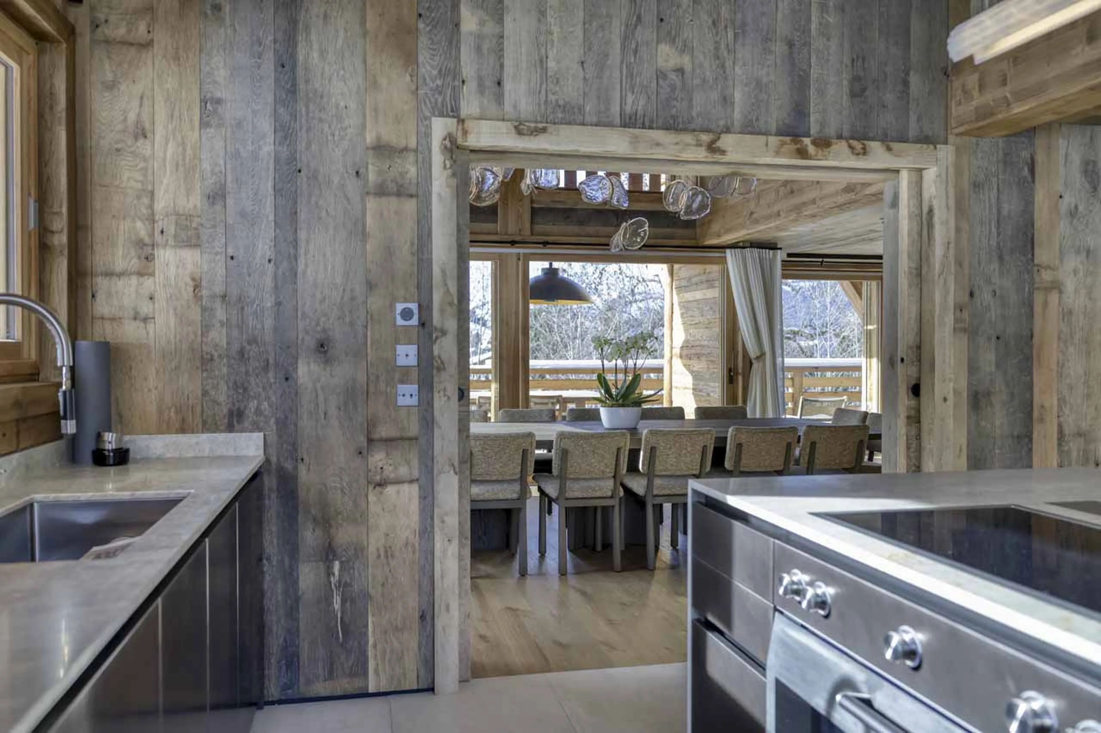 Dining table and kitchen at Chalet Cham Lou Ka in Megeve
