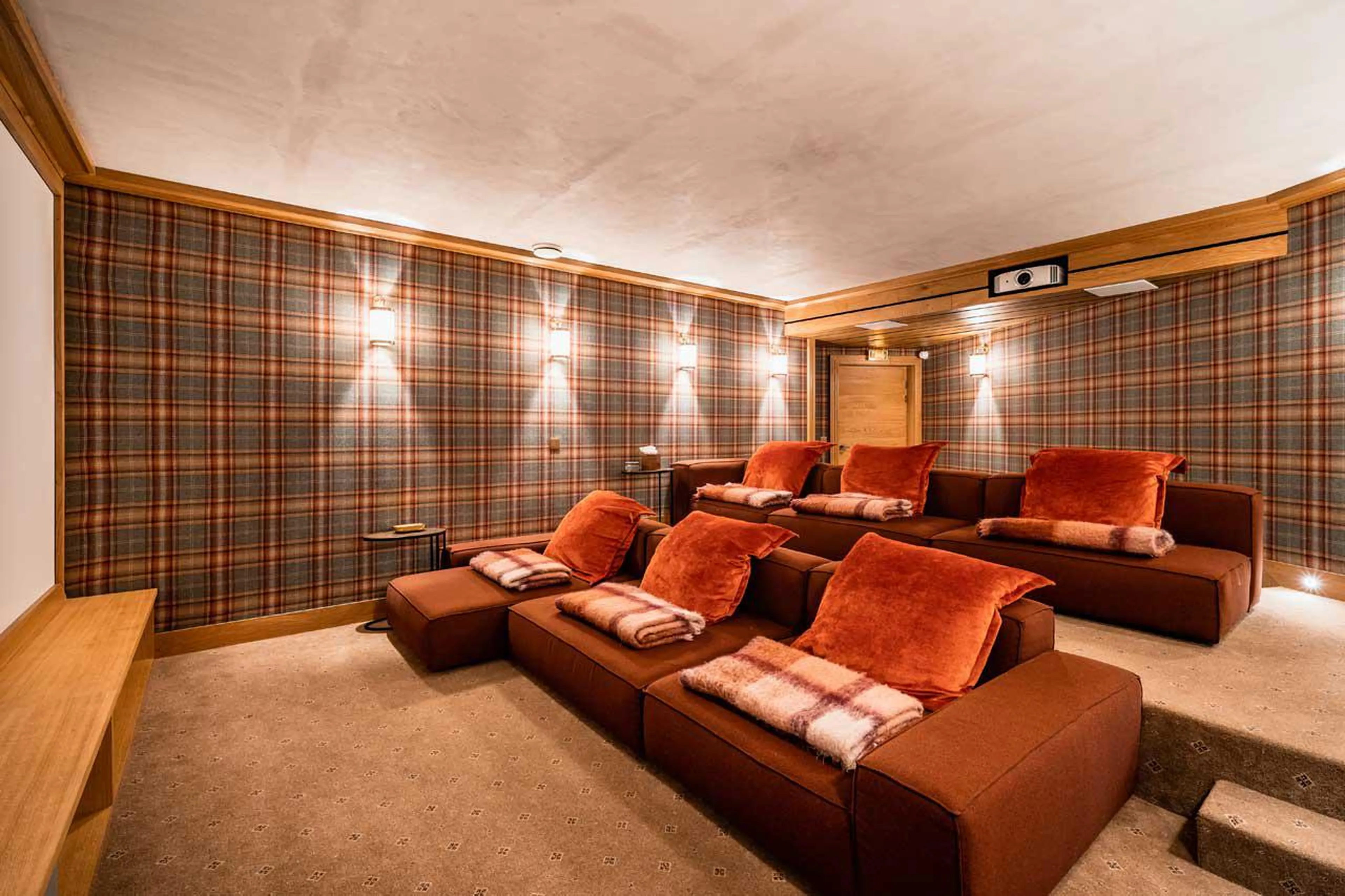 Spacious, authentic style cinema room with comfortable couches in Chalet Chene in Val d’ Isere