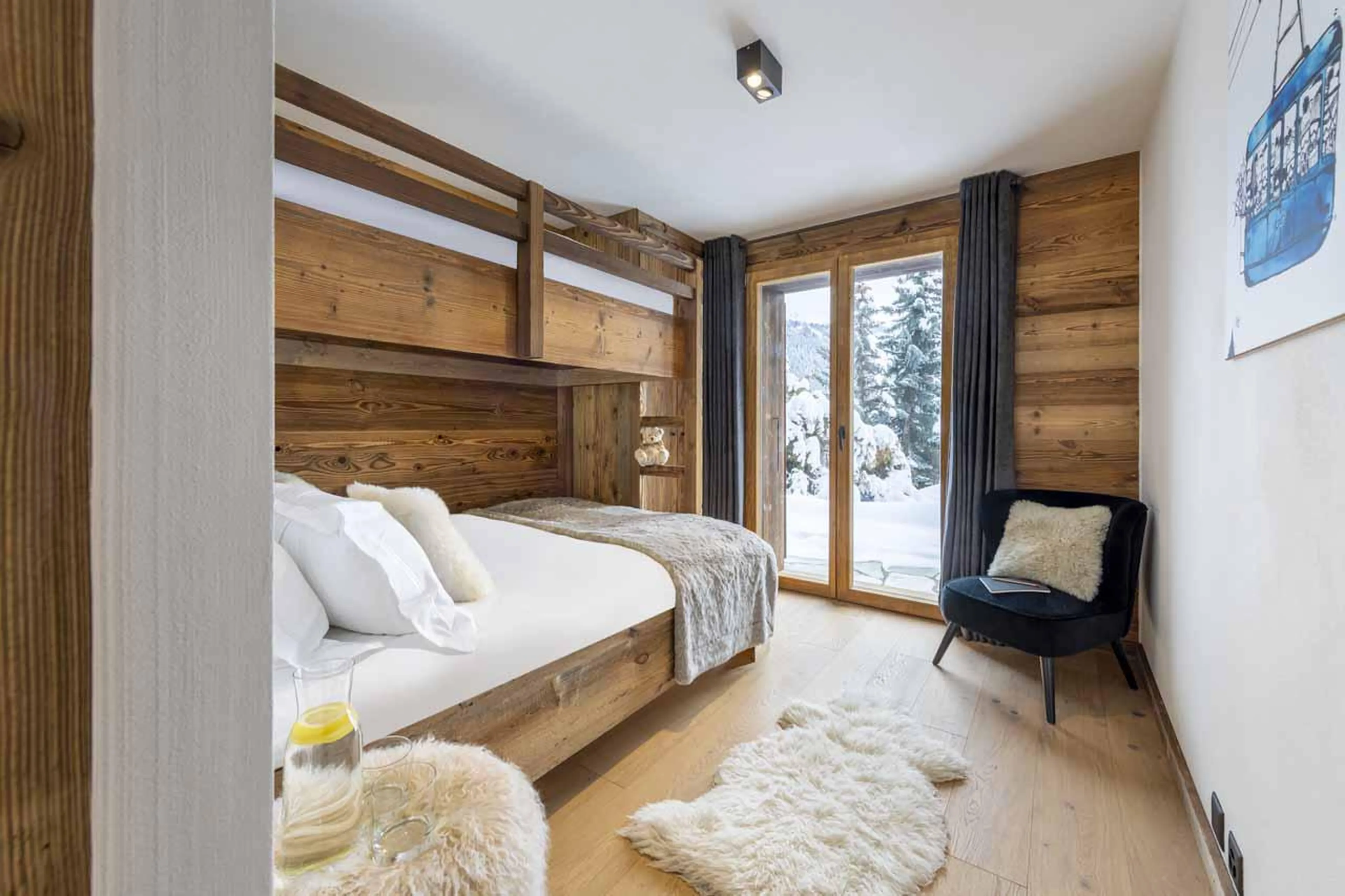 Bunk room with terrace access and en-suite shower room at Chalet Cortil in Verbier