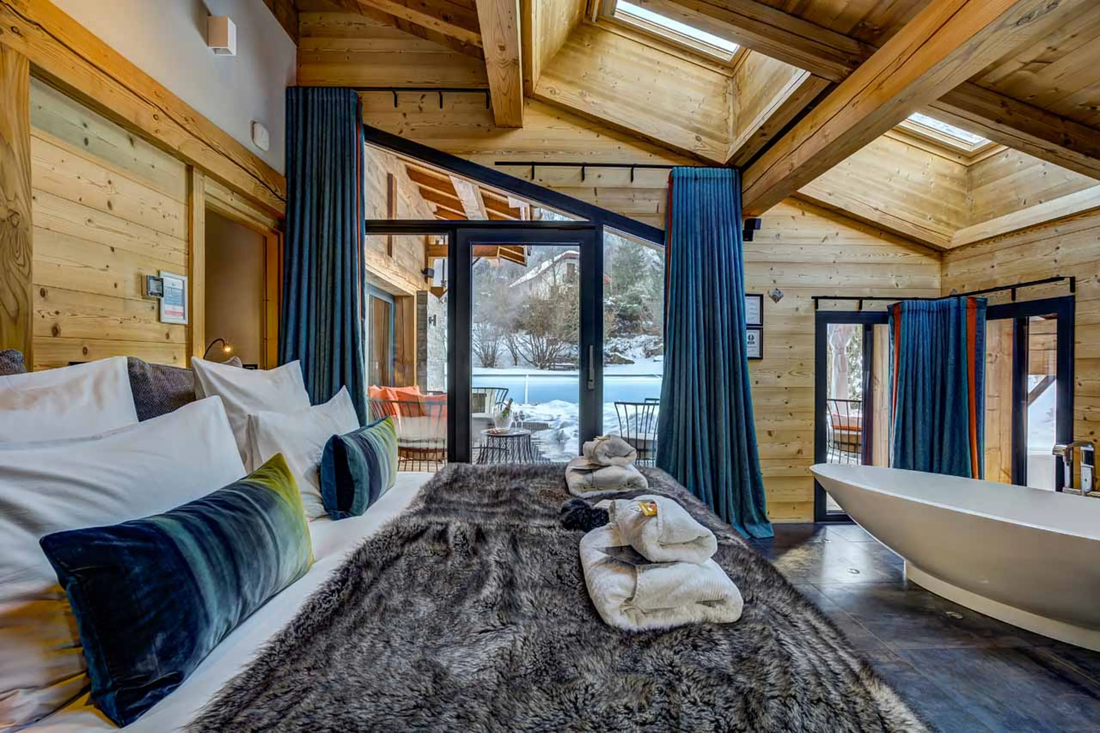 Master bedroom with in-room bath and terrace access in Chalet Couttet in Chamonix