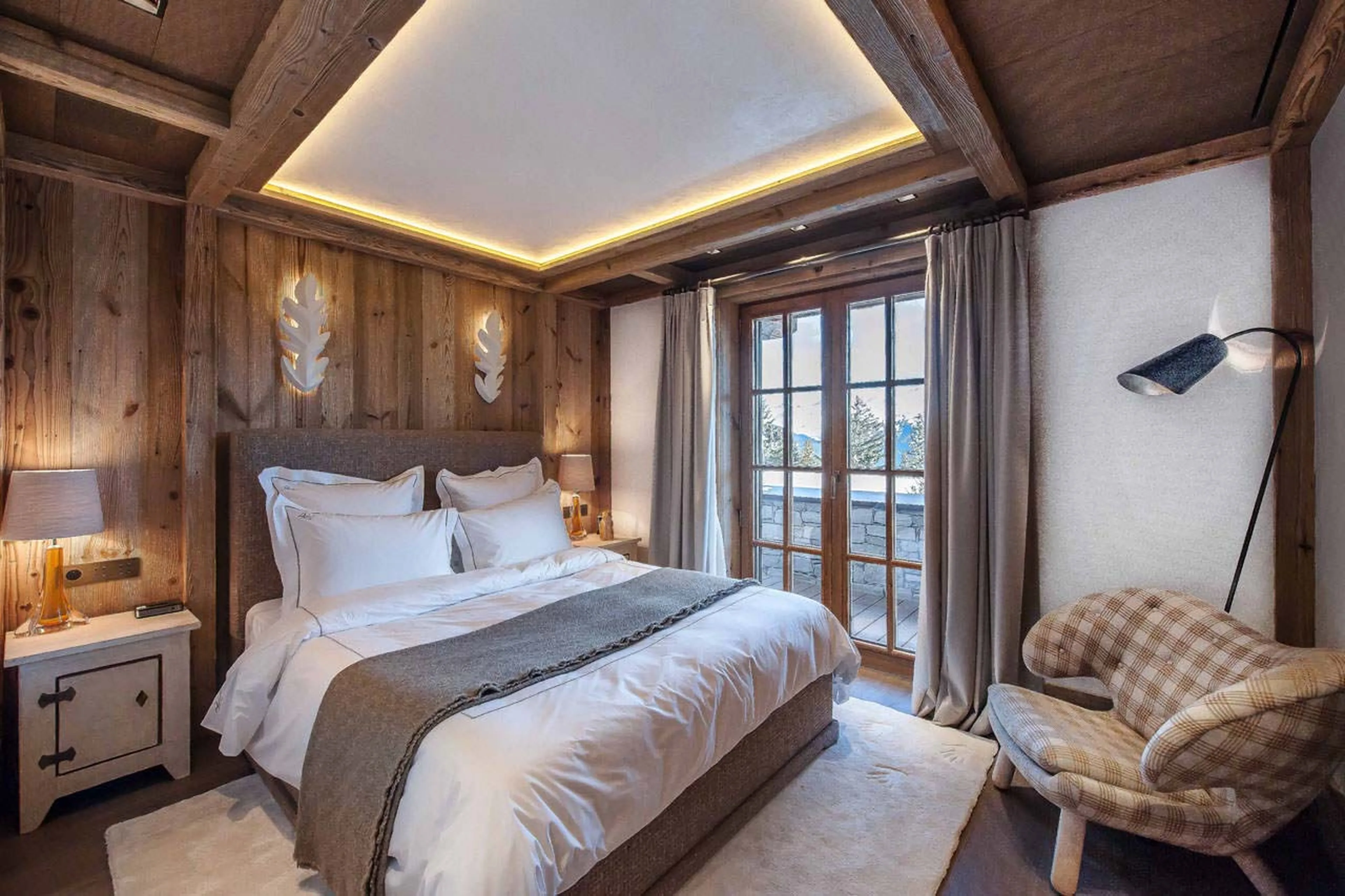 En suite double bedroom with balcony access in Chalet Cryst'Aile in Courchevel 1850