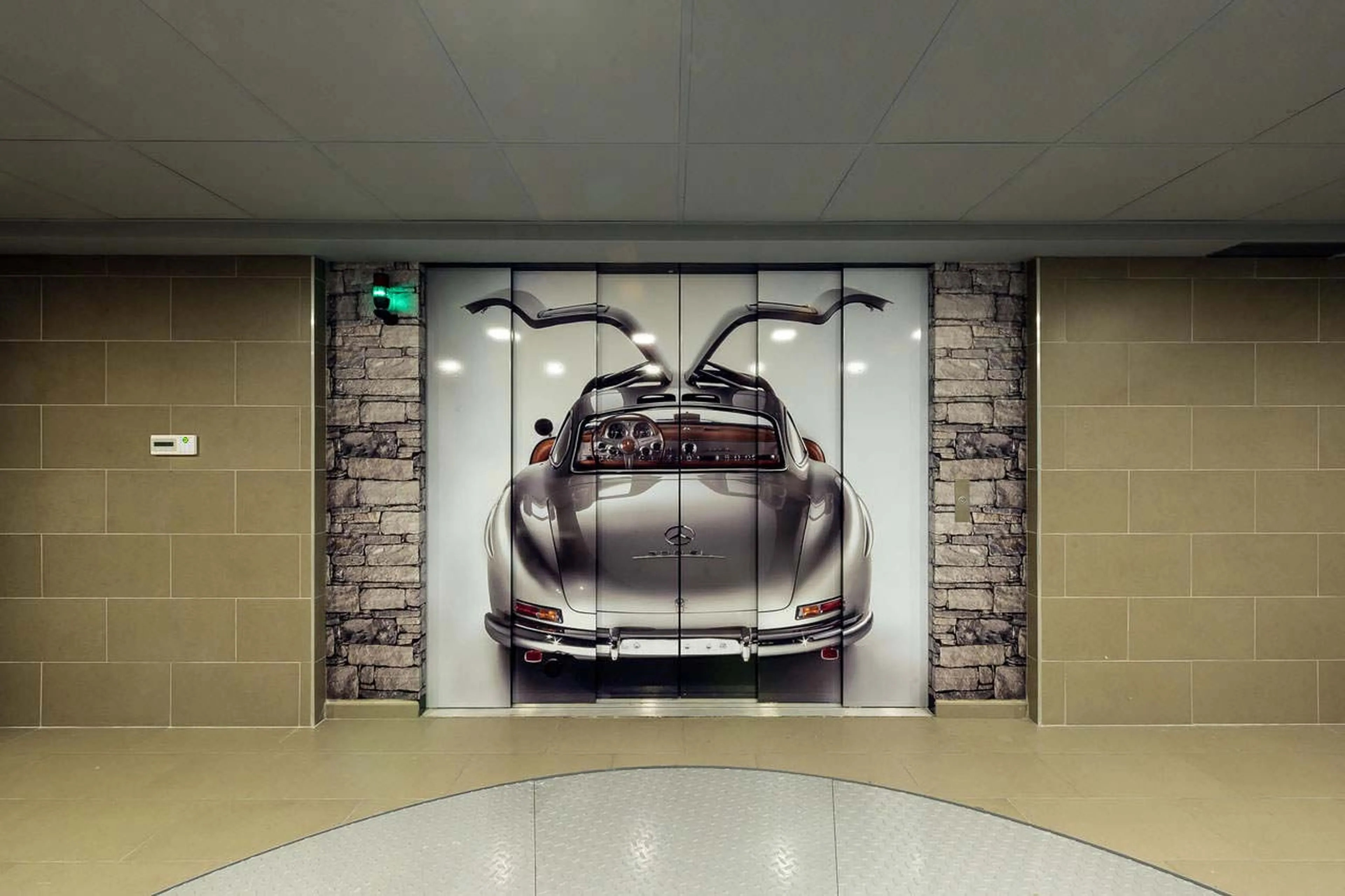 Garage with a car lift on one of the low levels in Chalet Cryst'Aile in Courchevel 1850