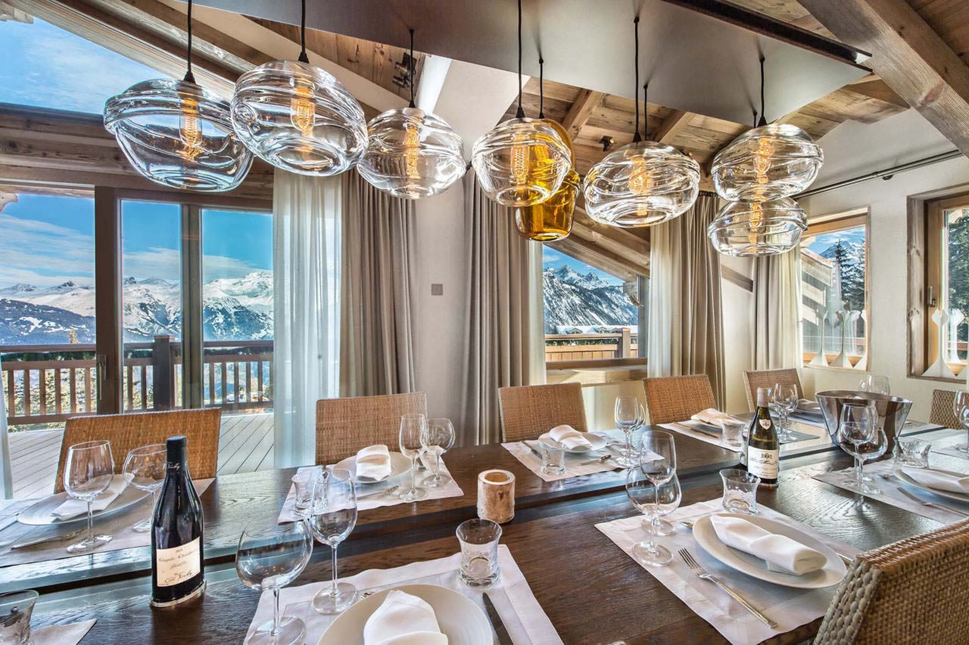Dining room with interesting lights above the table in Chalet Cryst'Aile in Courchevel 1850