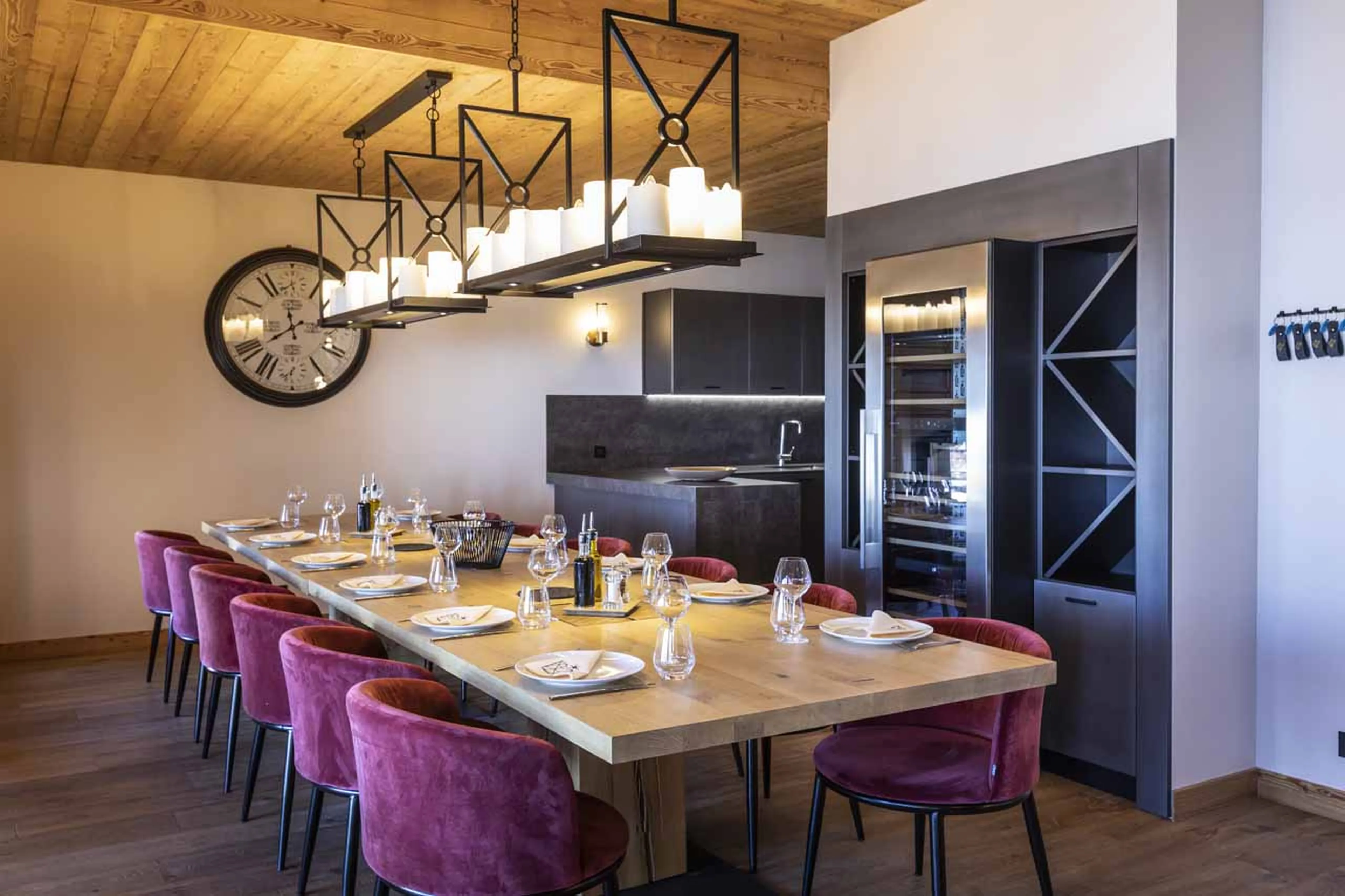 Dining table and kitchen at Chalet Cullinan in Val Thorens