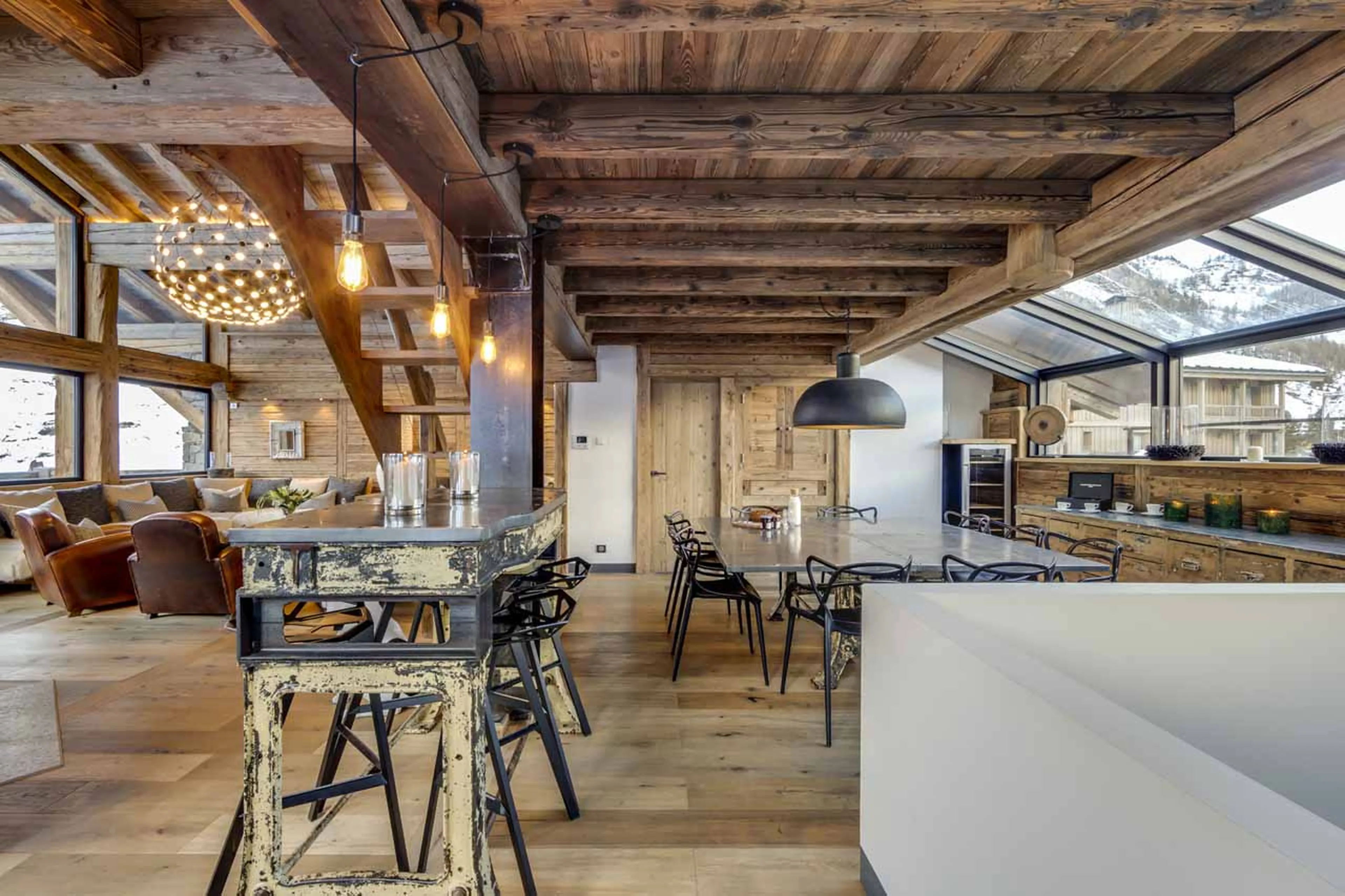 Dining area and kitchen at Chalet Daria in Val d'Isere