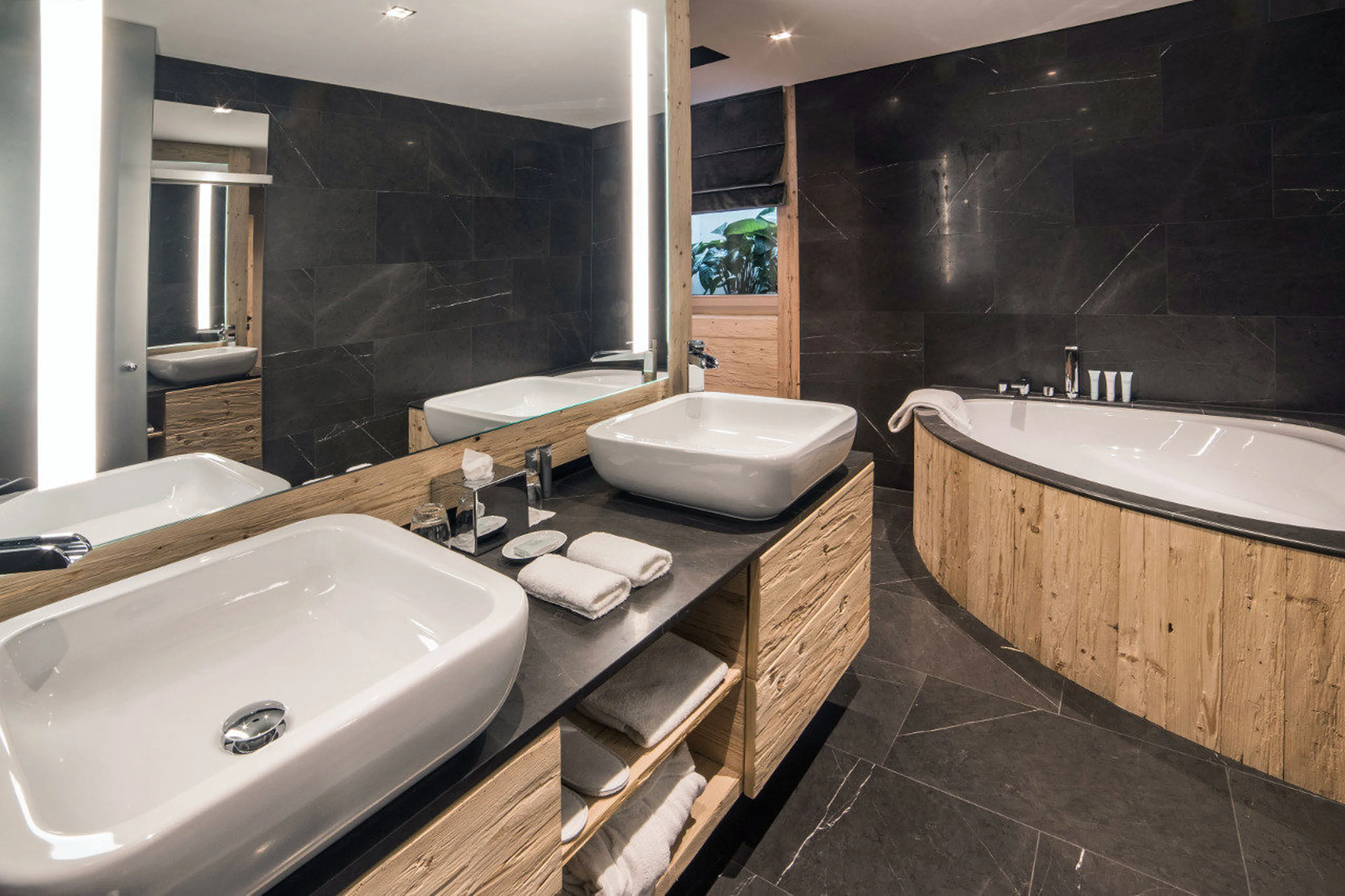 Bath and double basin in bathroom of double bedroom of Chalet de Rougemont in Gstaad