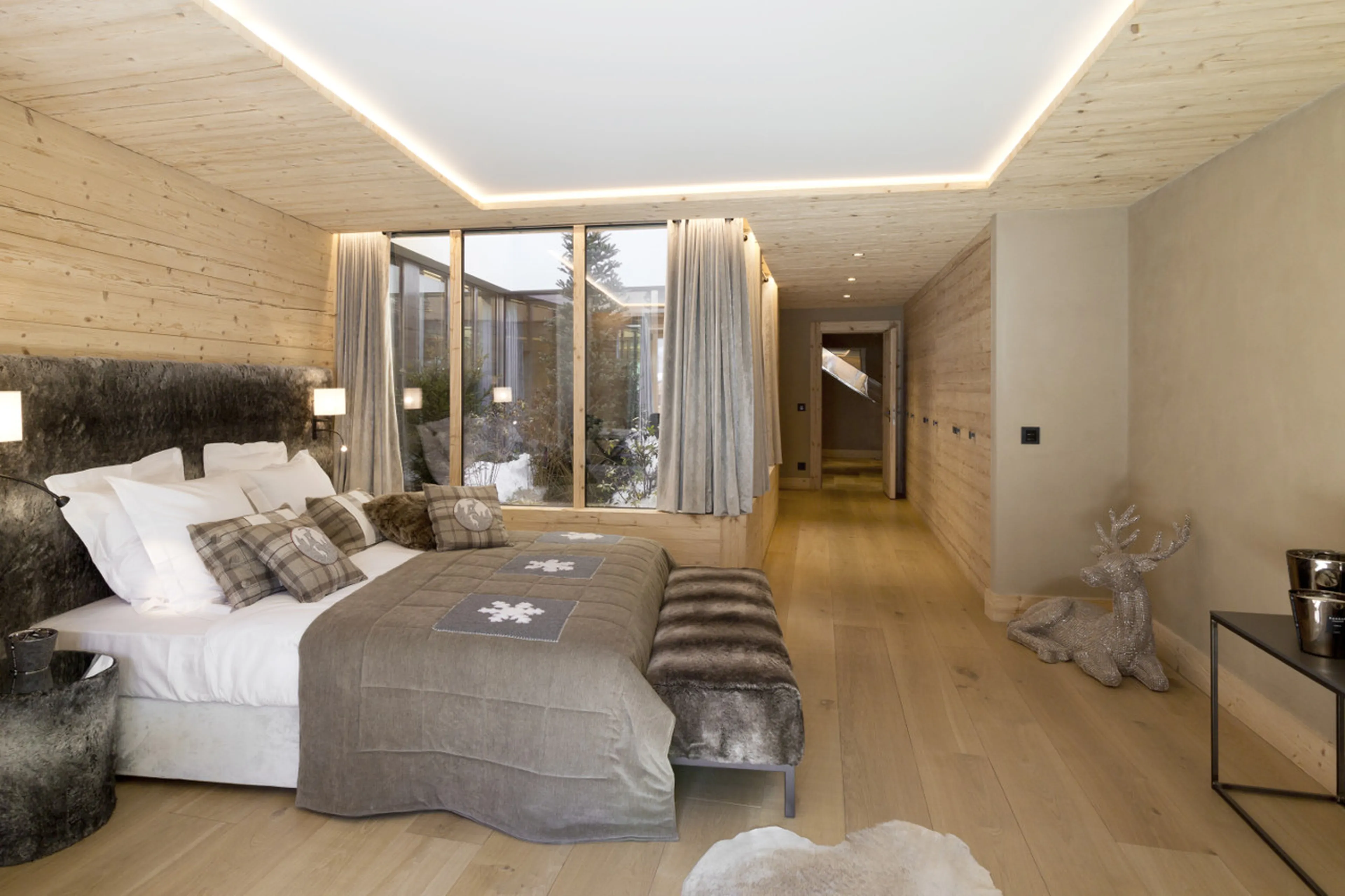 Double bedroom with terrarium, dressing area and en-suite bathroom in Chalet de Rougemont in Gstaad