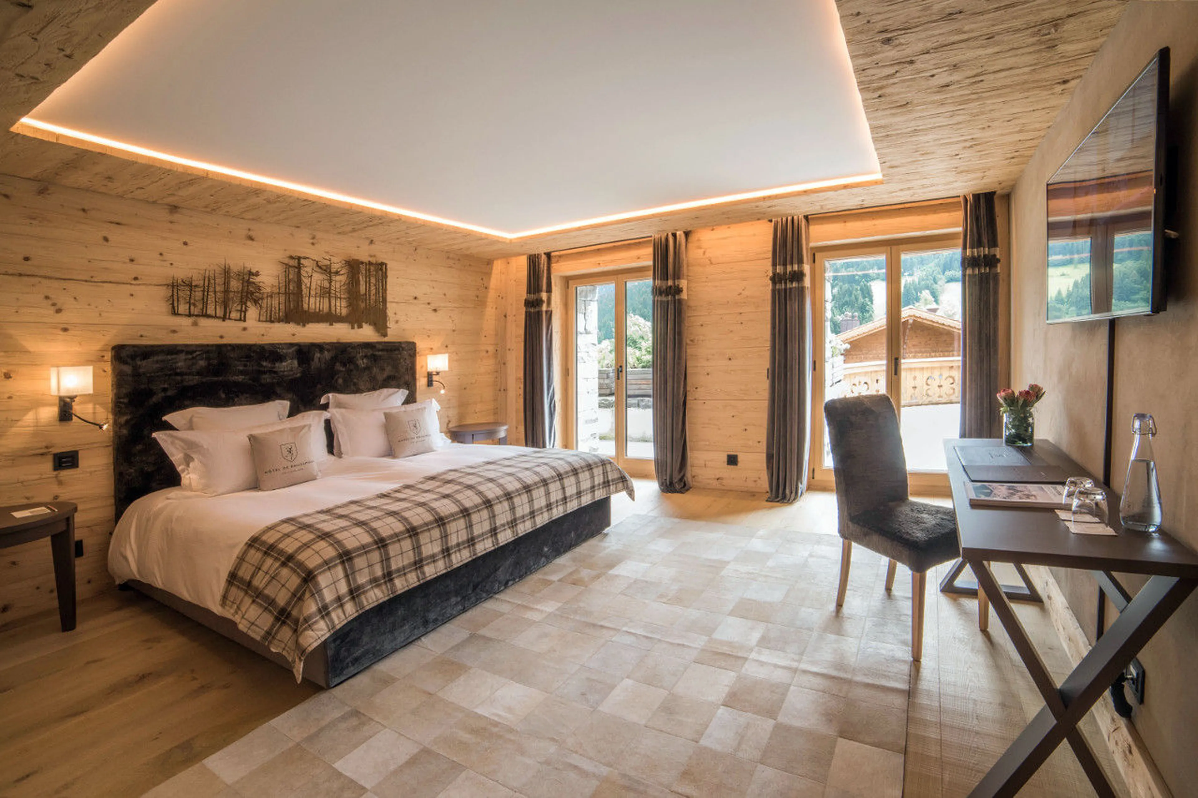 Double en-suite bedroom with direct terrace access in Chalet Rougemont in Gstaad
