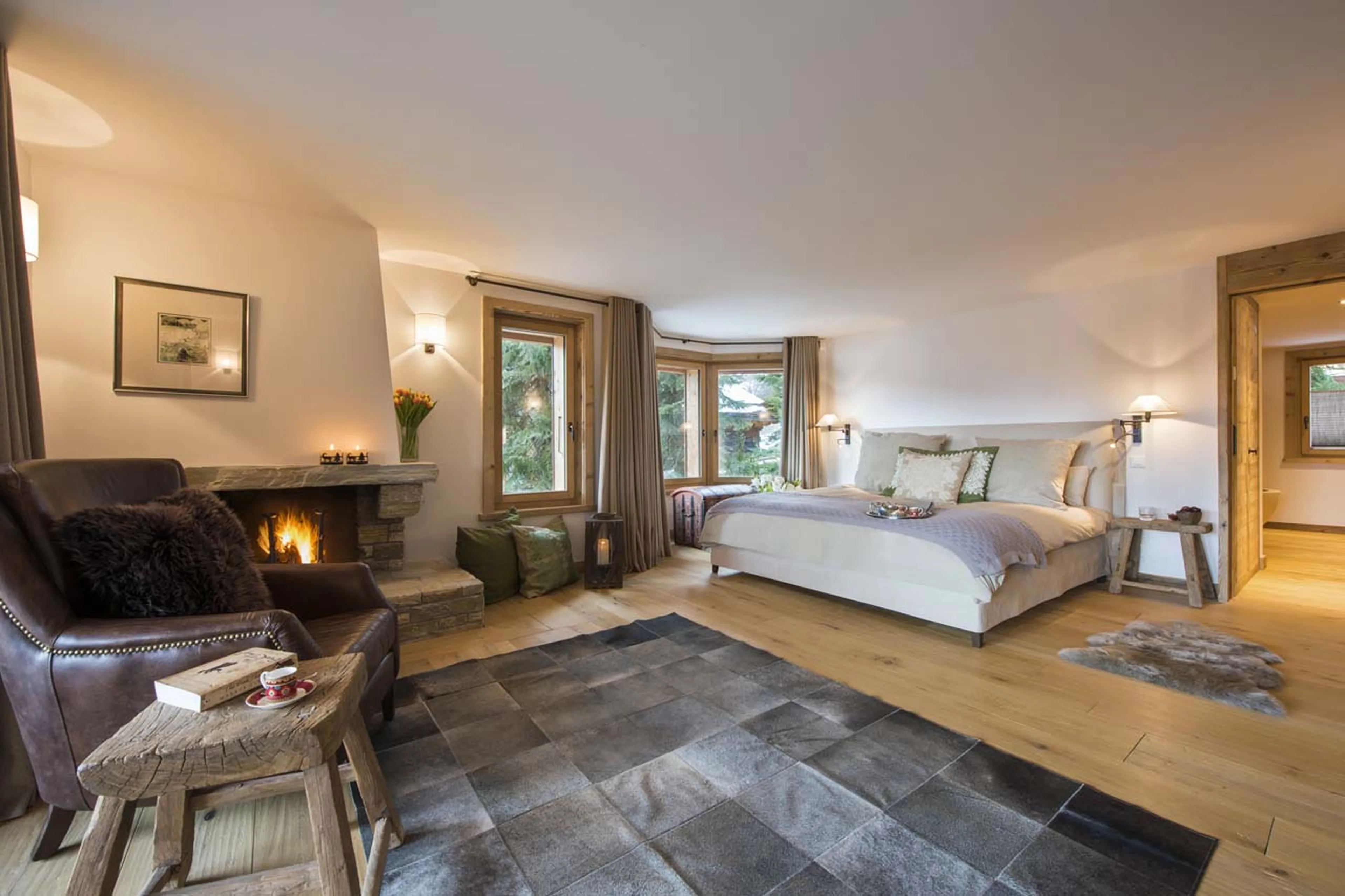 Master bedroom with fireplace in Chalet Delormes in Verbier