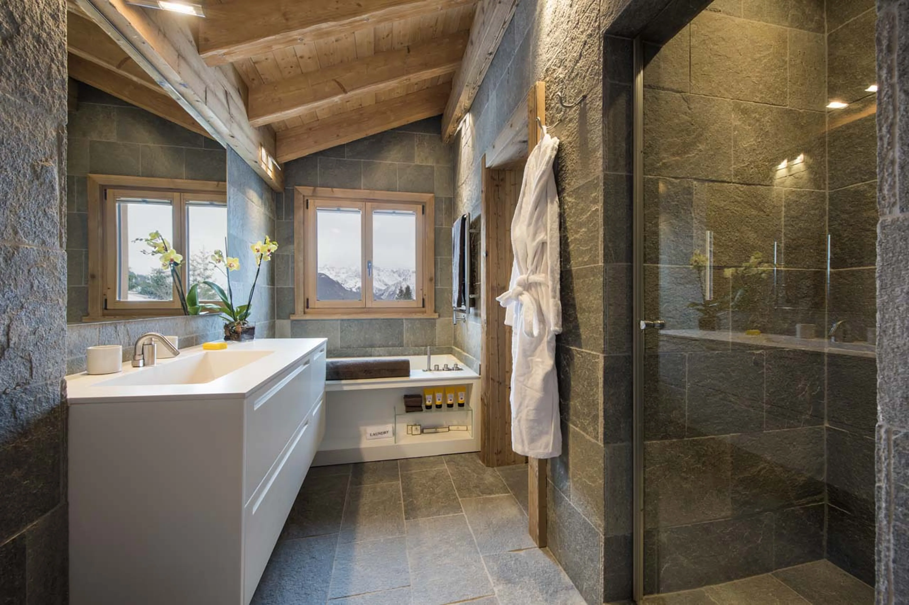Shower and bath tub in shared en-suite bathroom in Chalet Delormes in Verbier