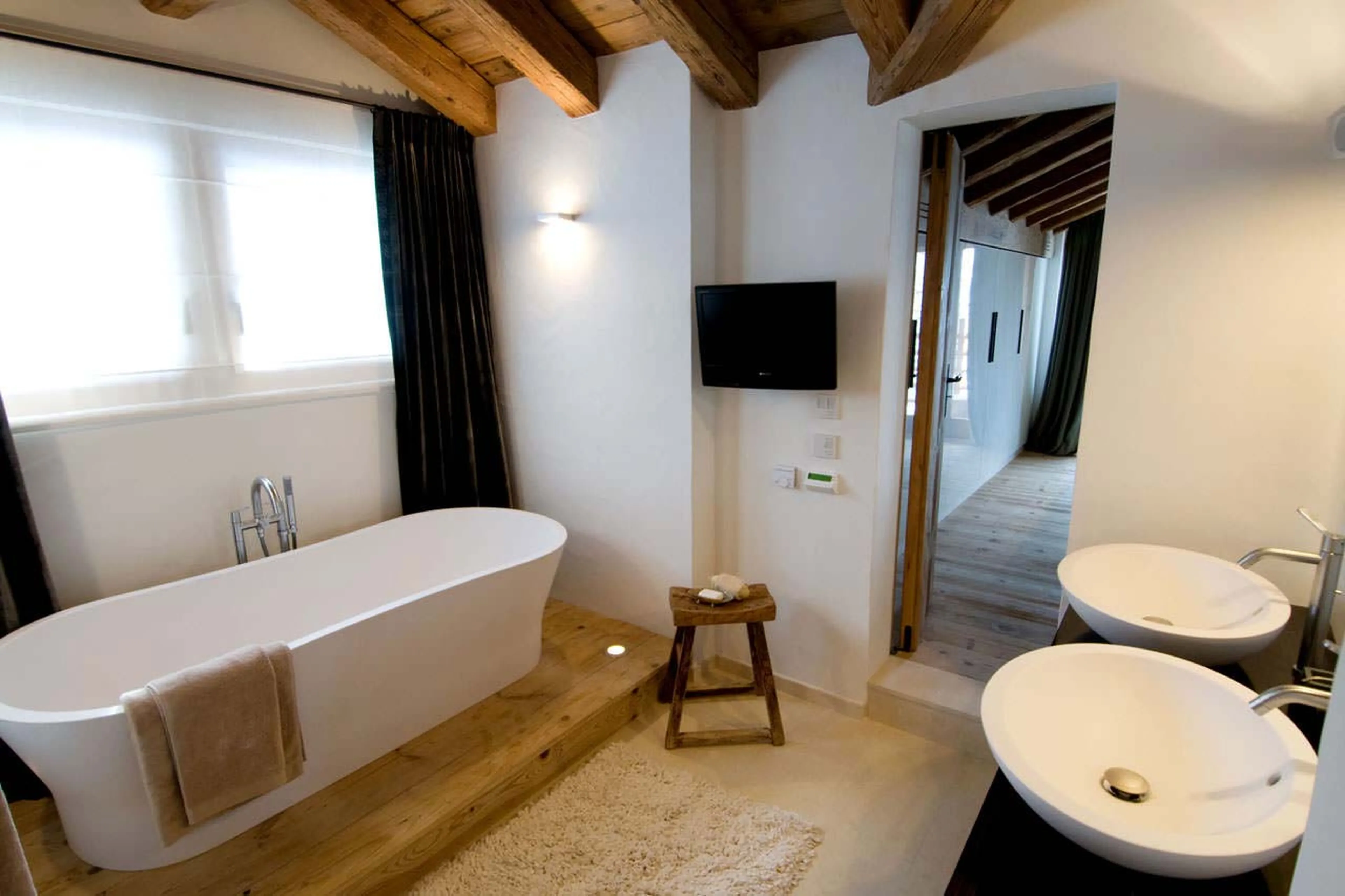 TV in master bathroom at  Chalet Dent Blanche in Verbier