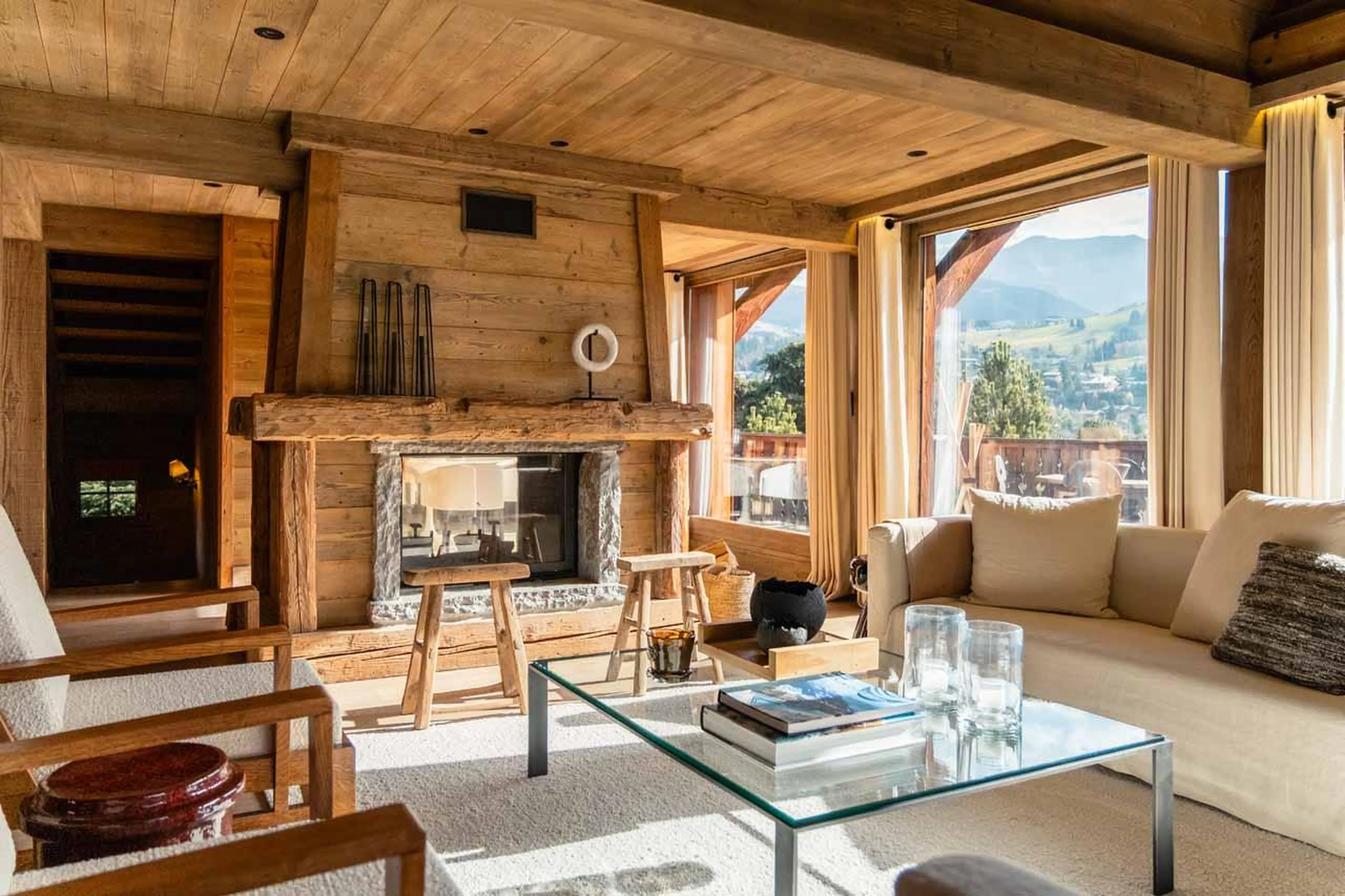 Sofas and coffee table in front of fireplace in Chalet Donatien, Megeve