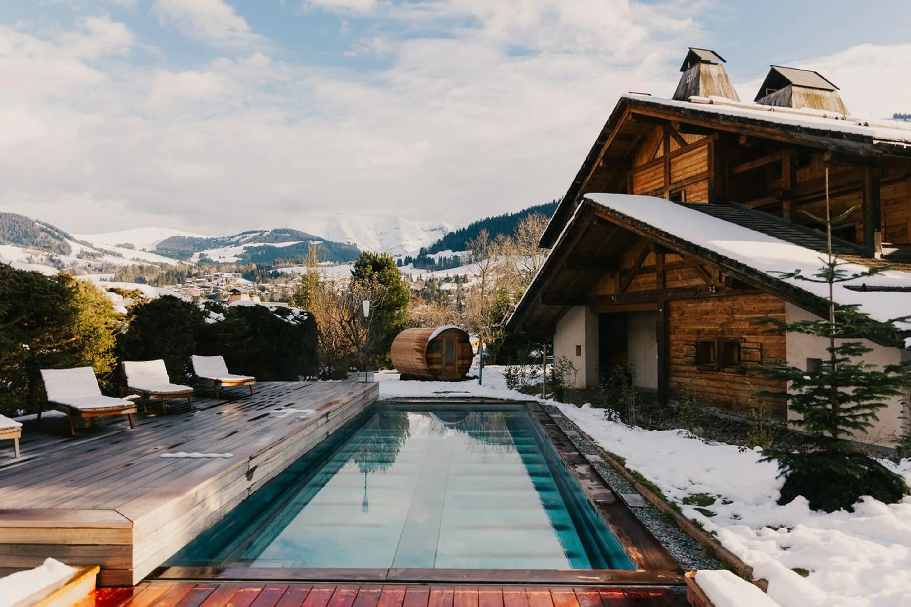 Outdoor pool with sun loungers on terrace in Chalet Donatien, Megeve