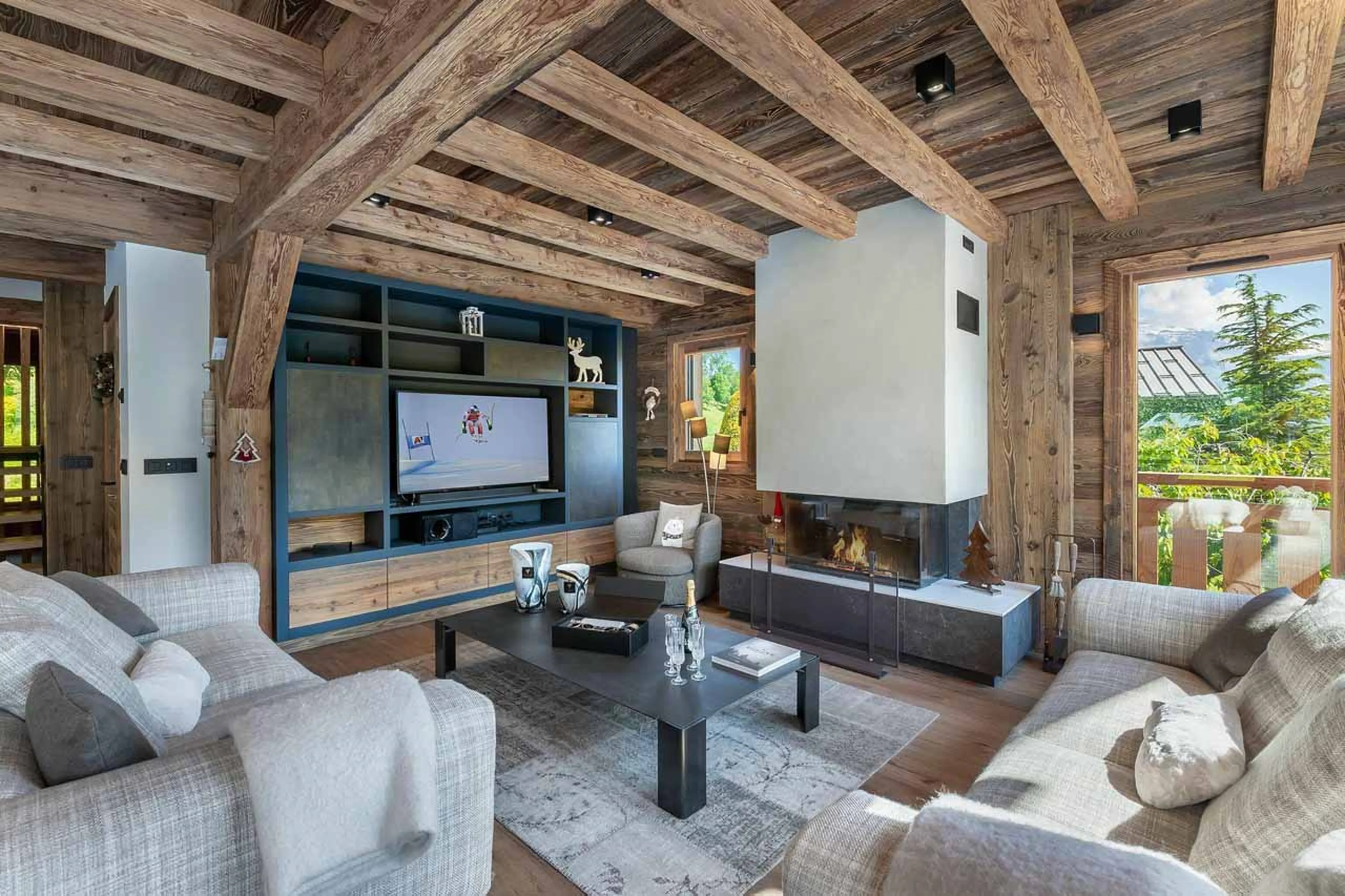 Open plan living area with fireplace at Chalet Eastwood in Megeve