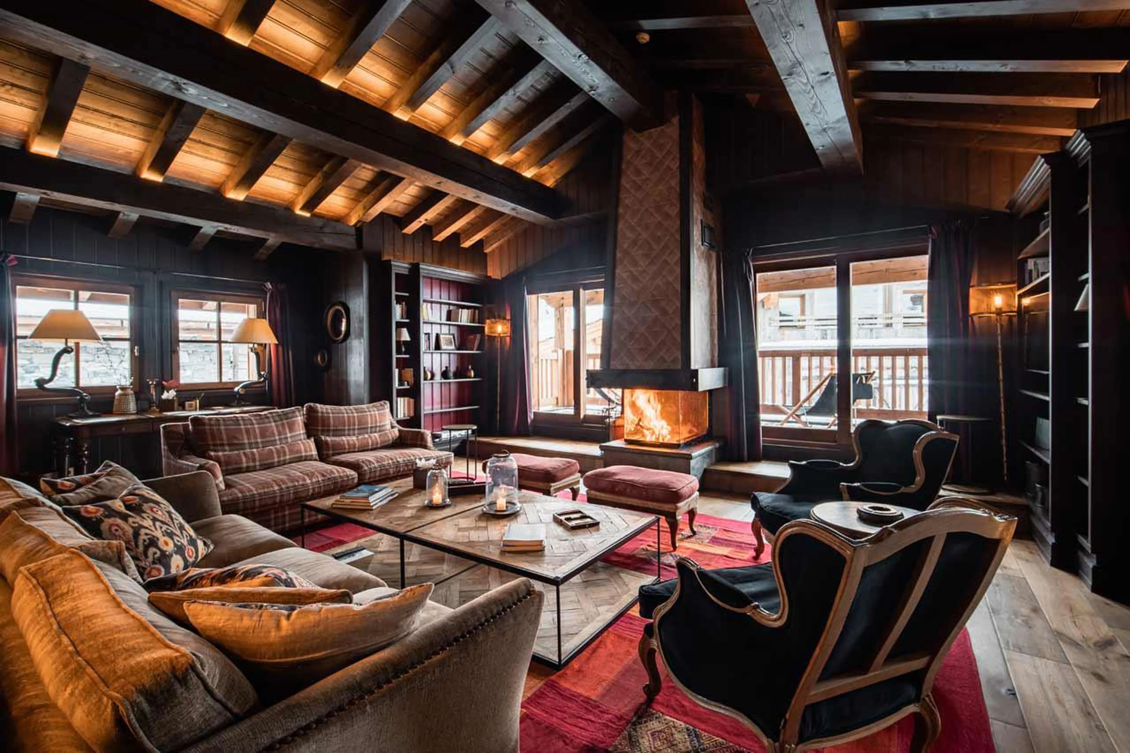 The fireplace creates a cosy atmosphere in the living area of Chalet Ebene in Val d’ Isere