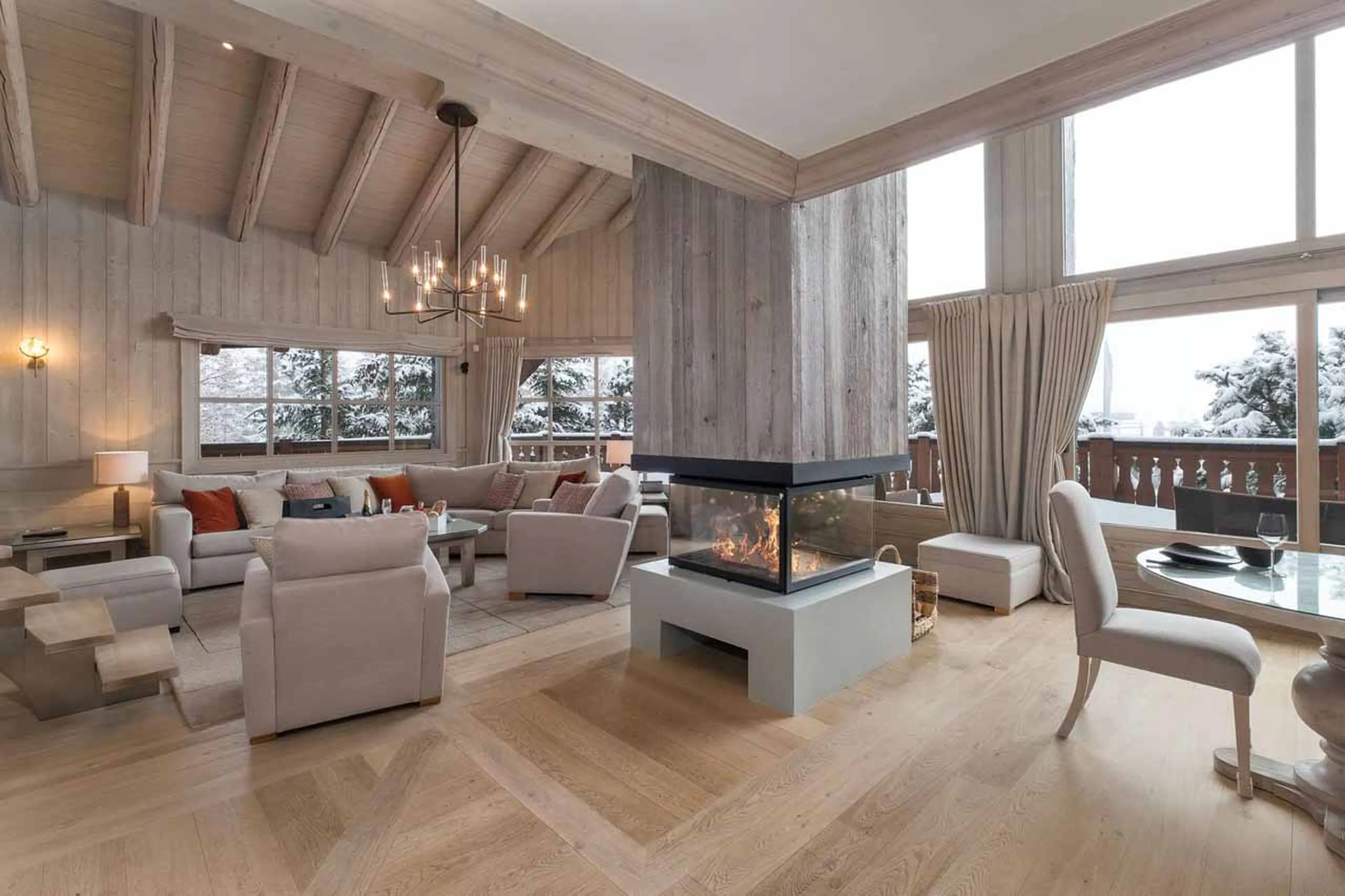 Living area with central fireplace in Chalet Edelstone, Courchevel 1850