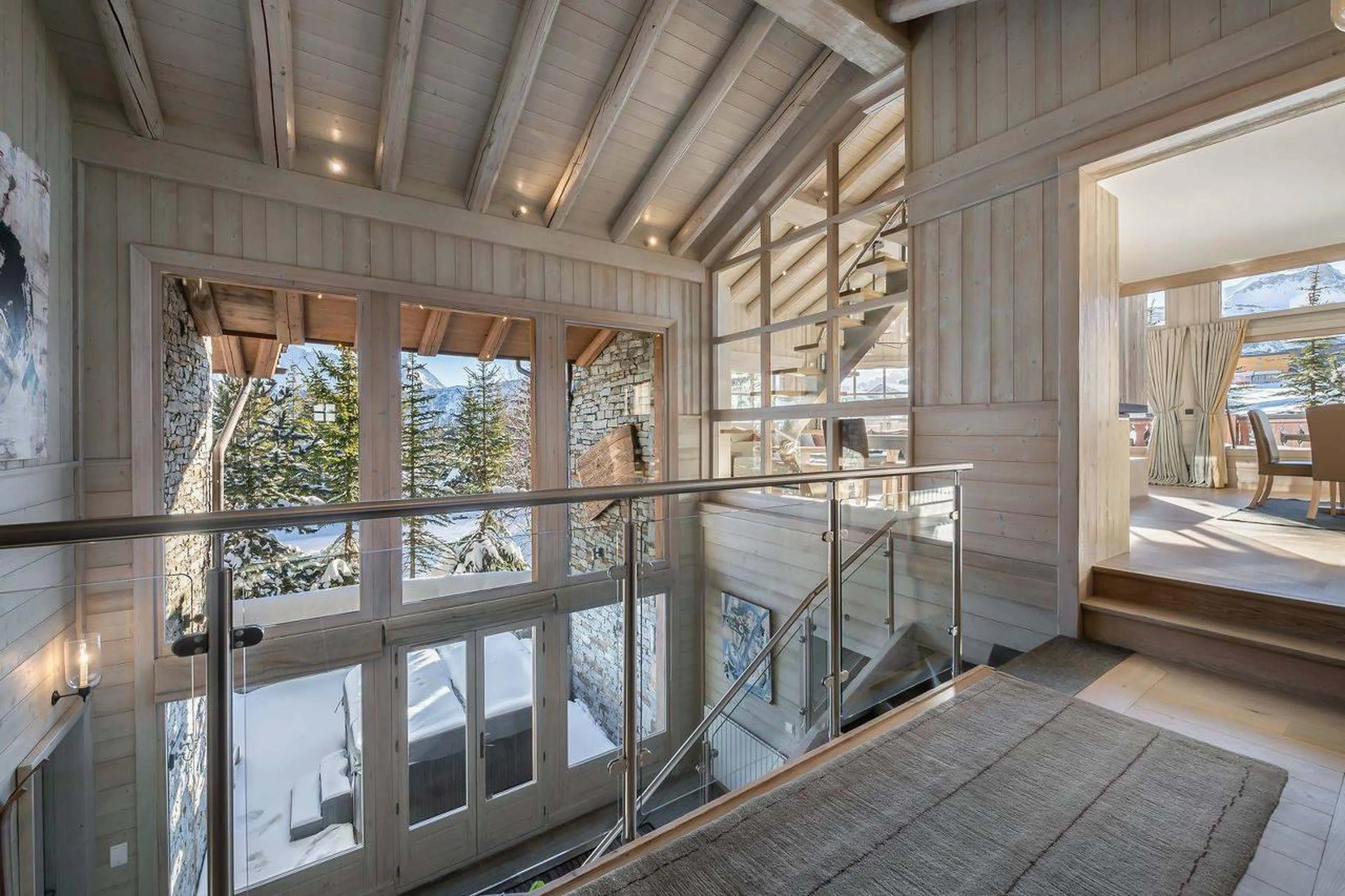 Central atrium with tall double storey windows in Chalet Edelstone in Courchevel 1850