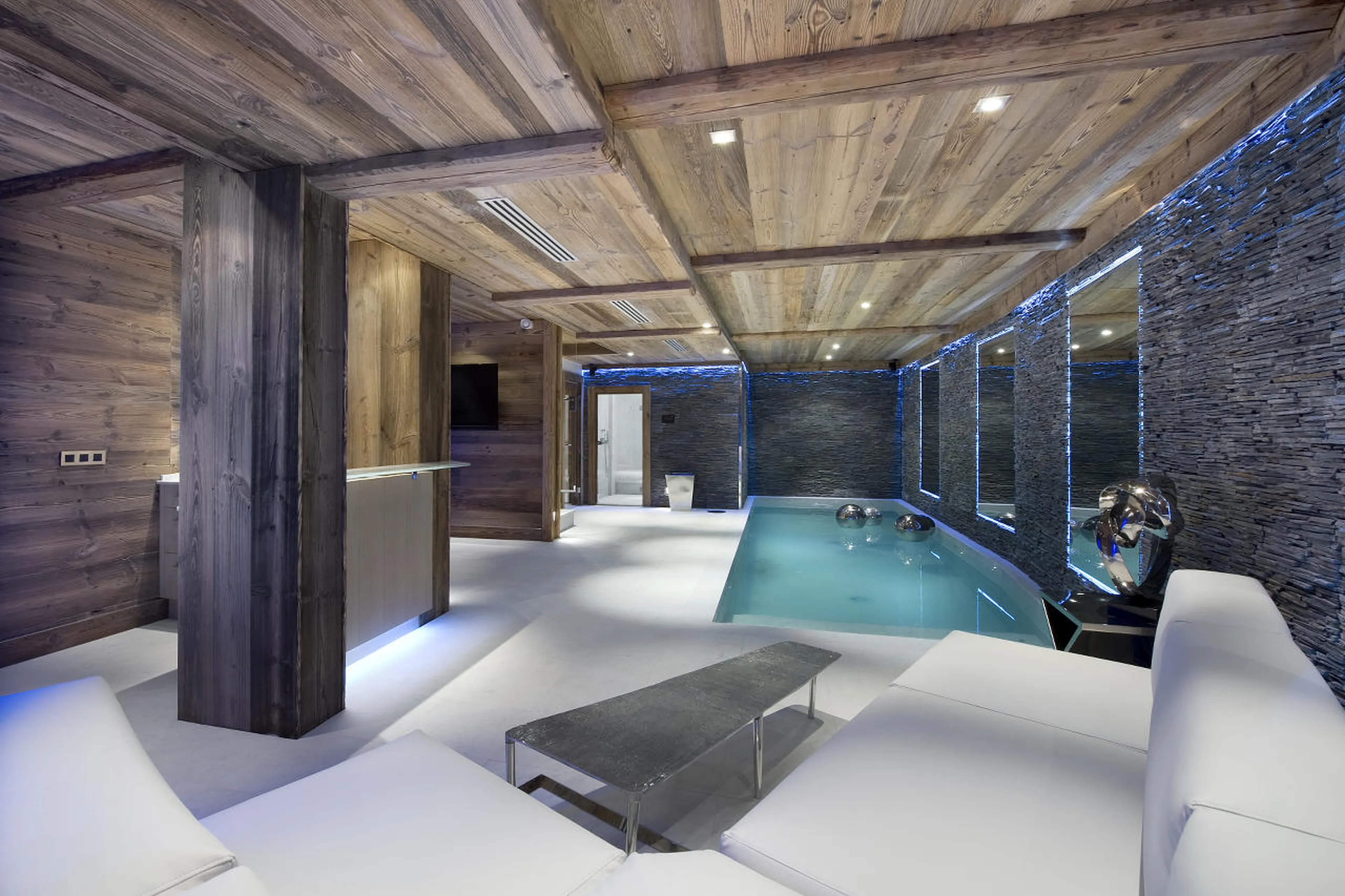 Lounge area and bar near pool in Chalet Eden in Courchevel 1850