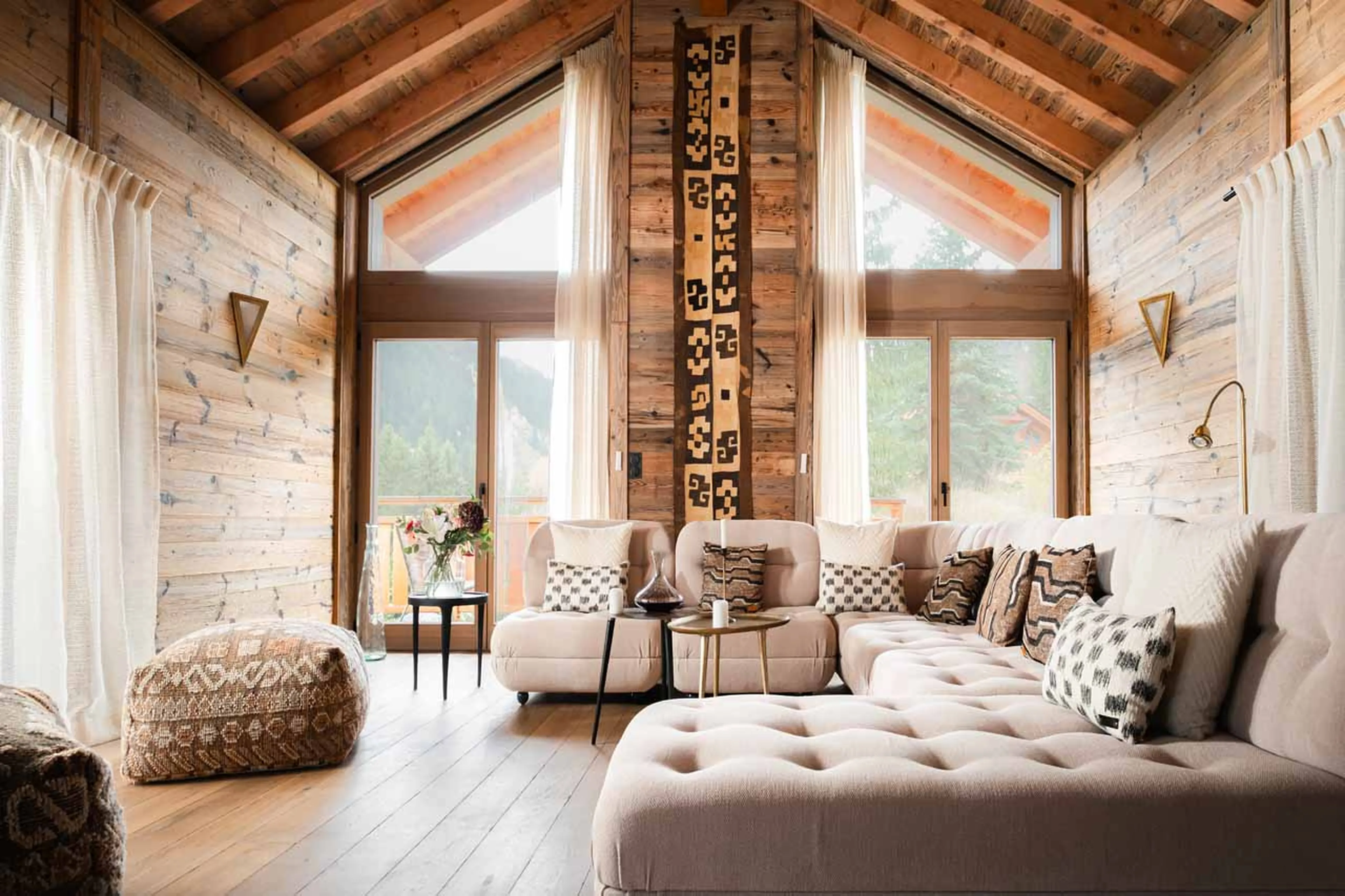 Living area and central fireplace at Chalet Elegie in Meribel